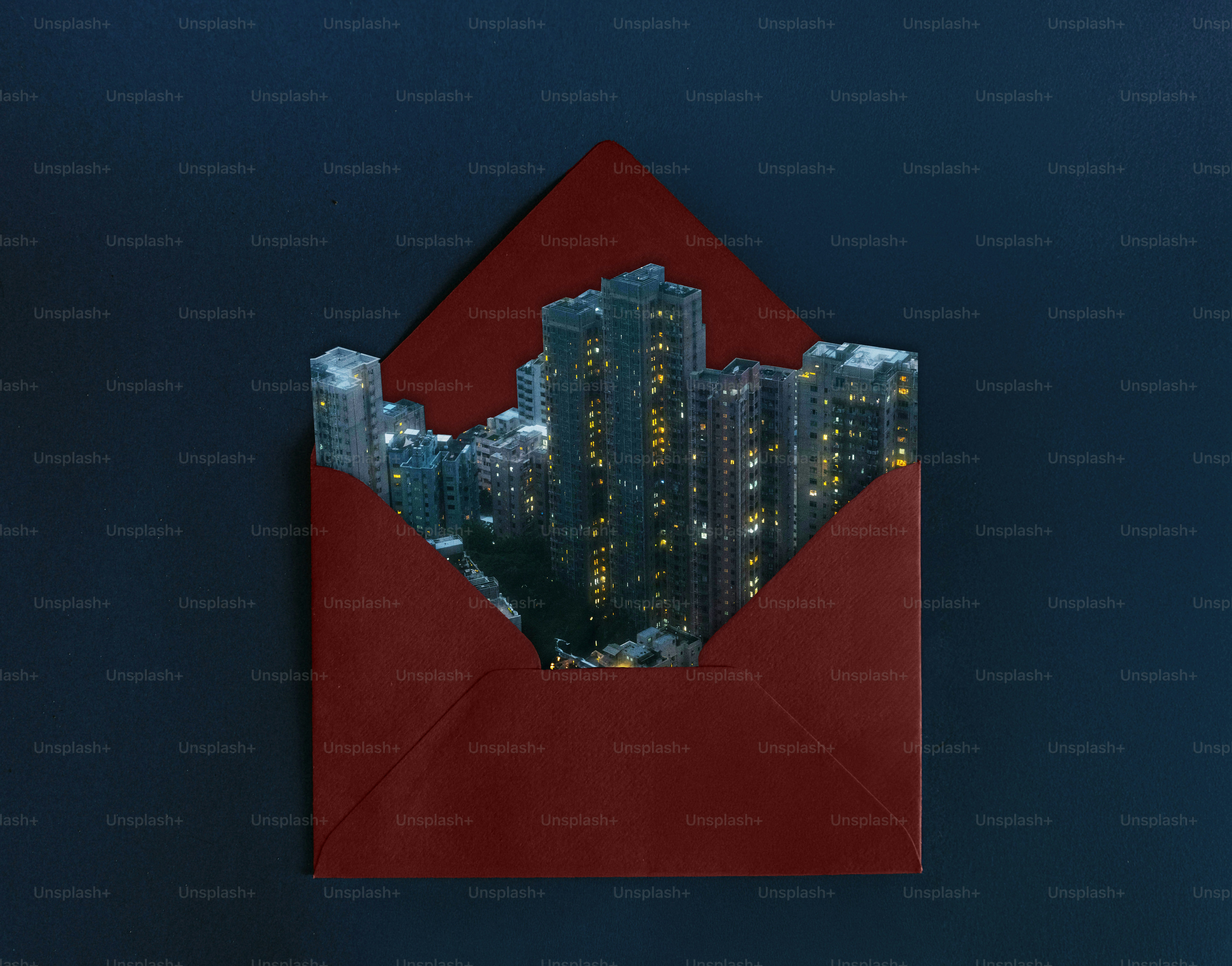 City skyline emerging from a red envelope.