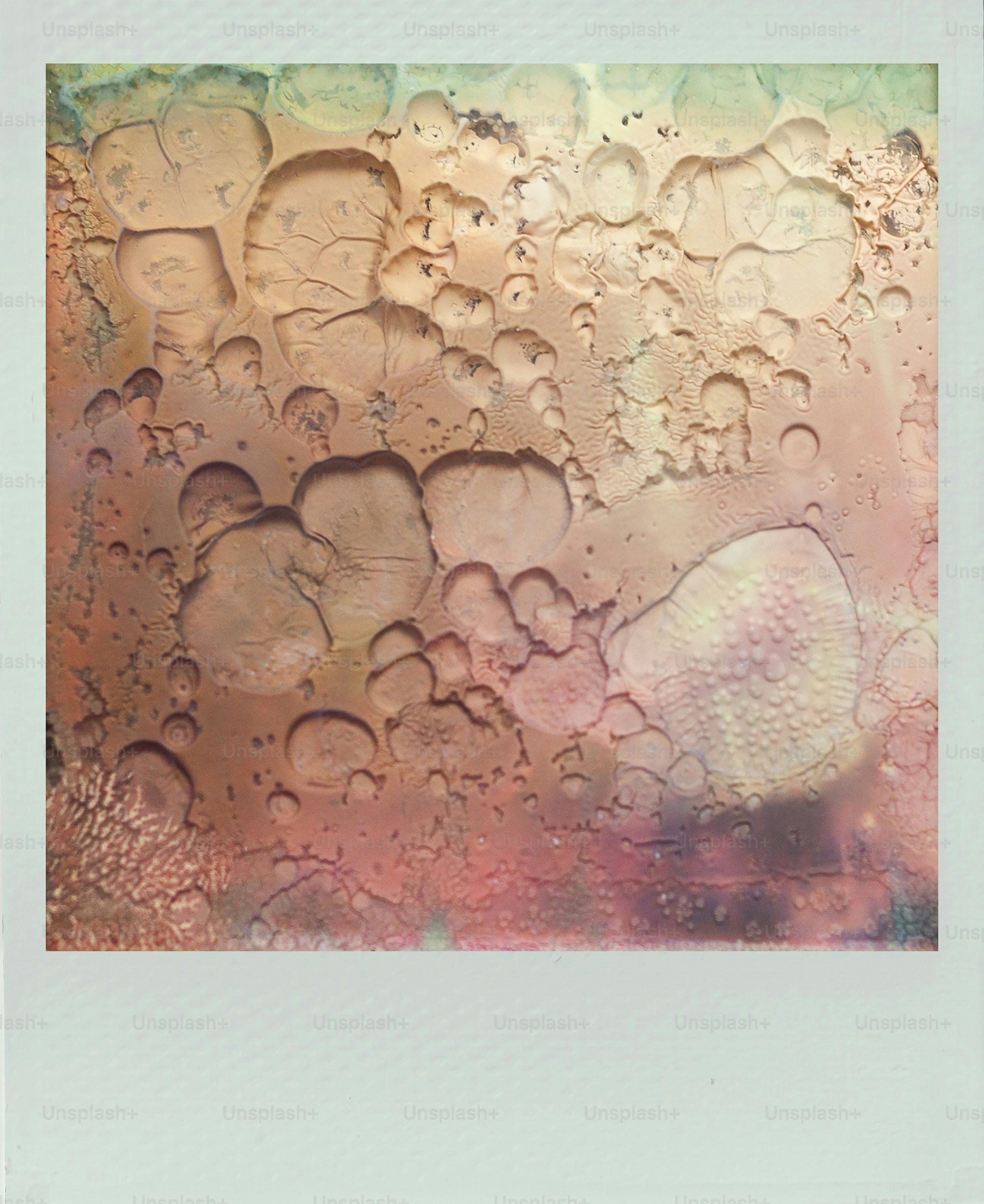 Abstract textured surface with pink and beige tones