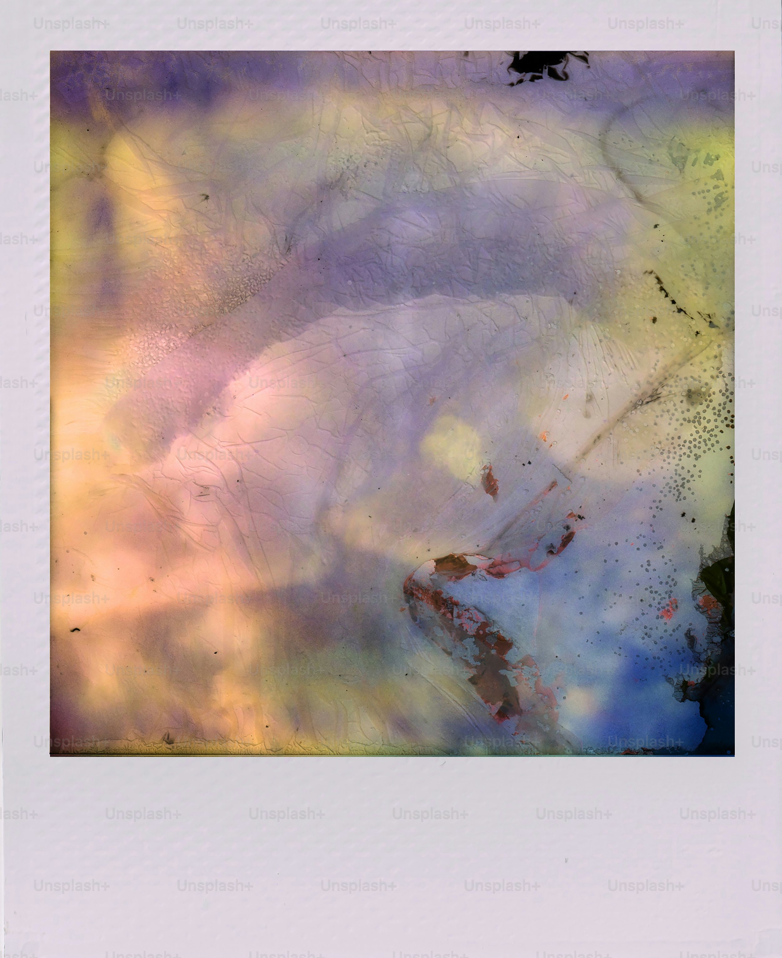 Abstract watercolor textures with purple, yellow, and blue hues.