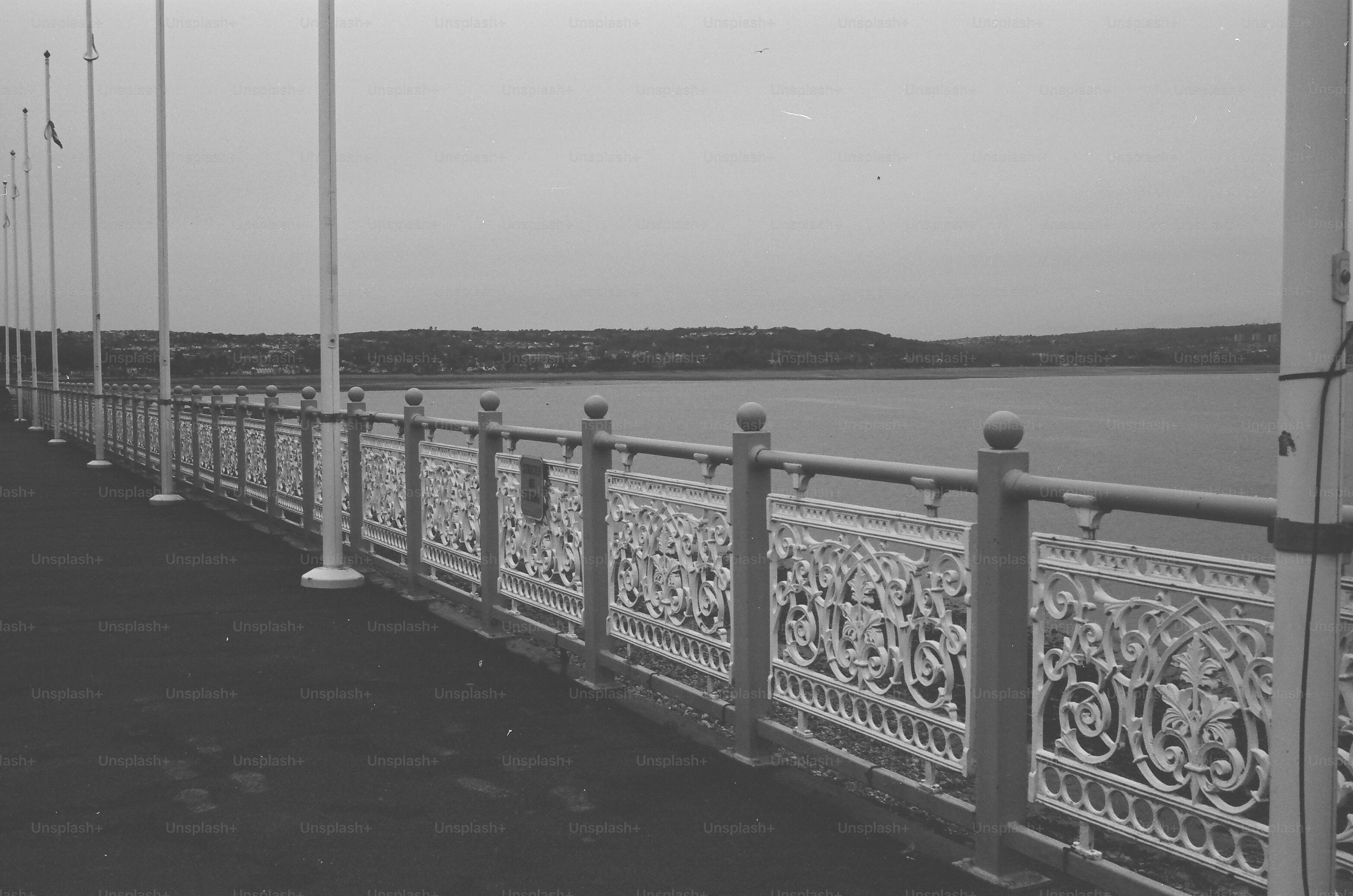 Ornate white railing along a waterfront promenade