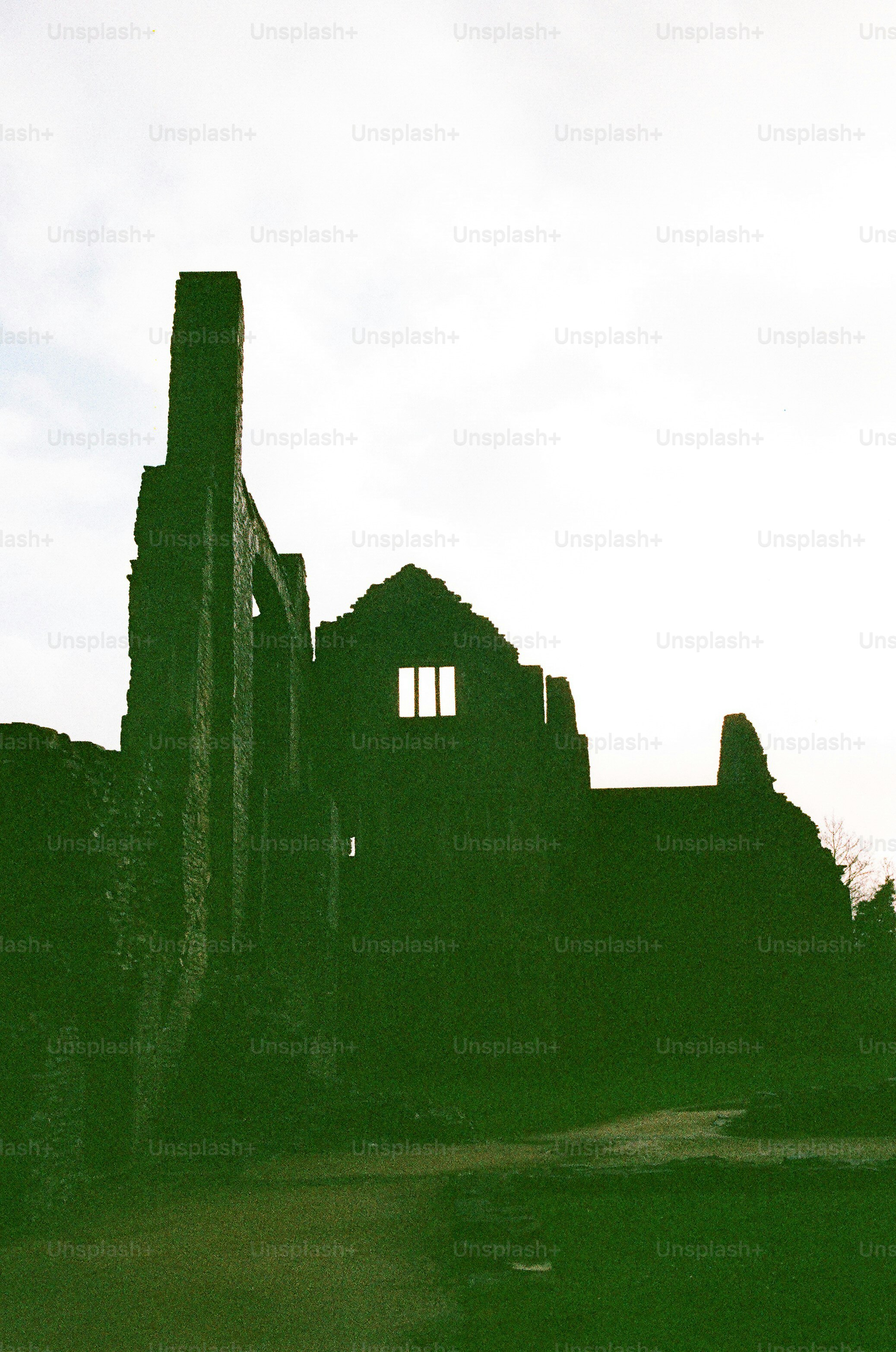 Silhouette of ancient stone ruins against a bright sky