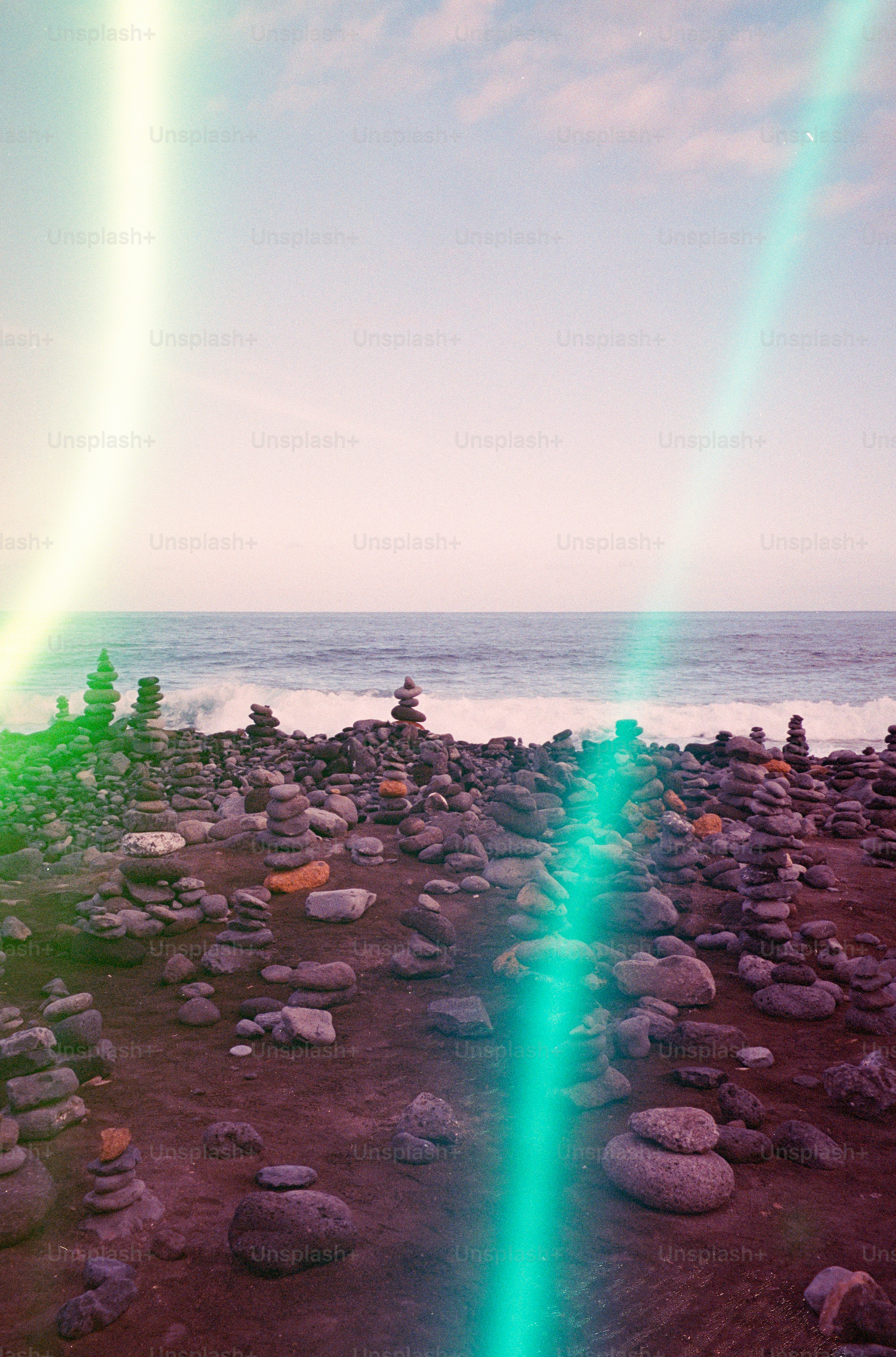 Stacked rocks on a beach with ocean waves. photo – Meditation Image on ...