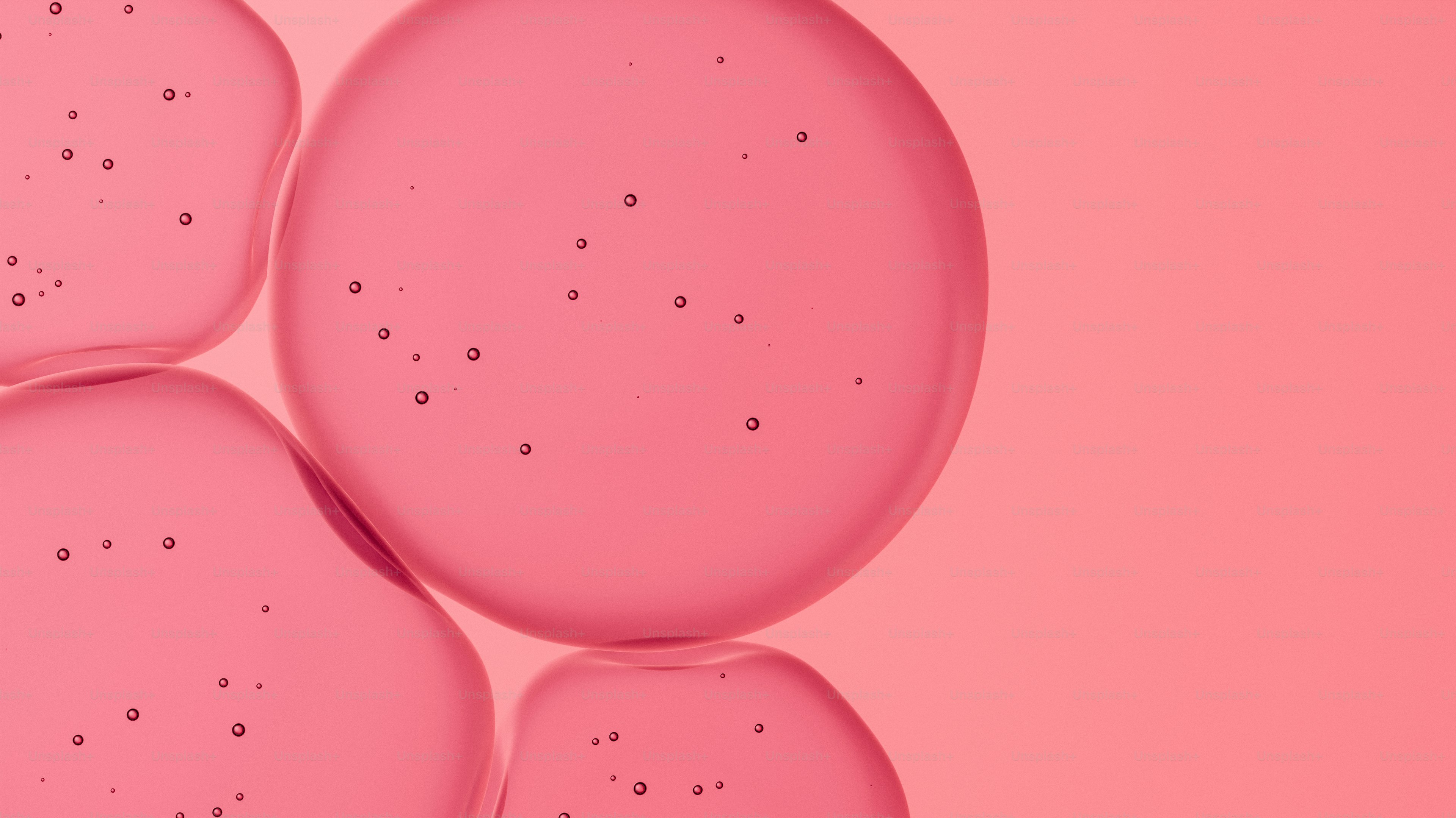 Pink blobs with small bubbles on a pink background