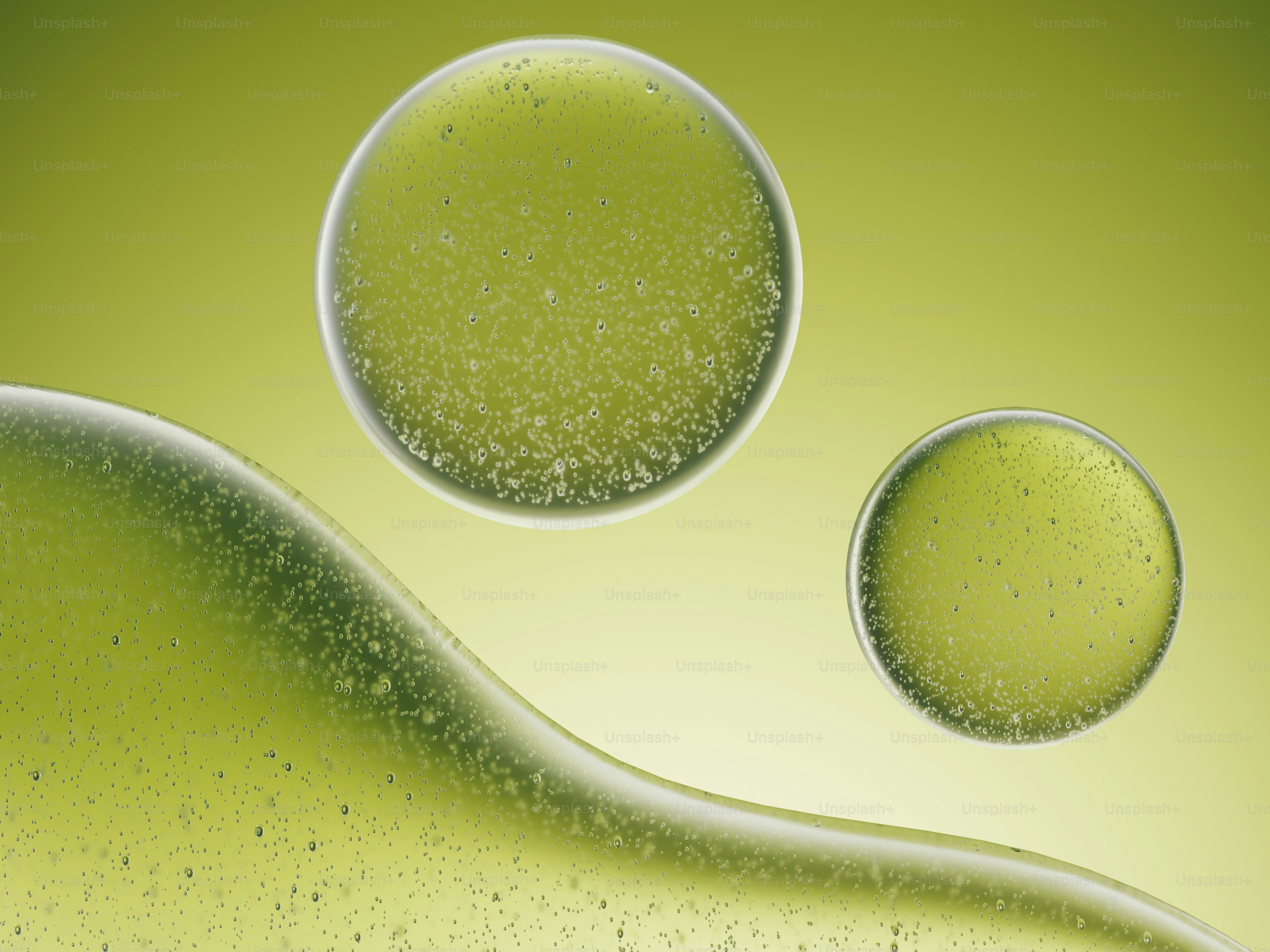 Grüne Flüssigkeit mit Blasen und Kugeln auf gelbem Grund