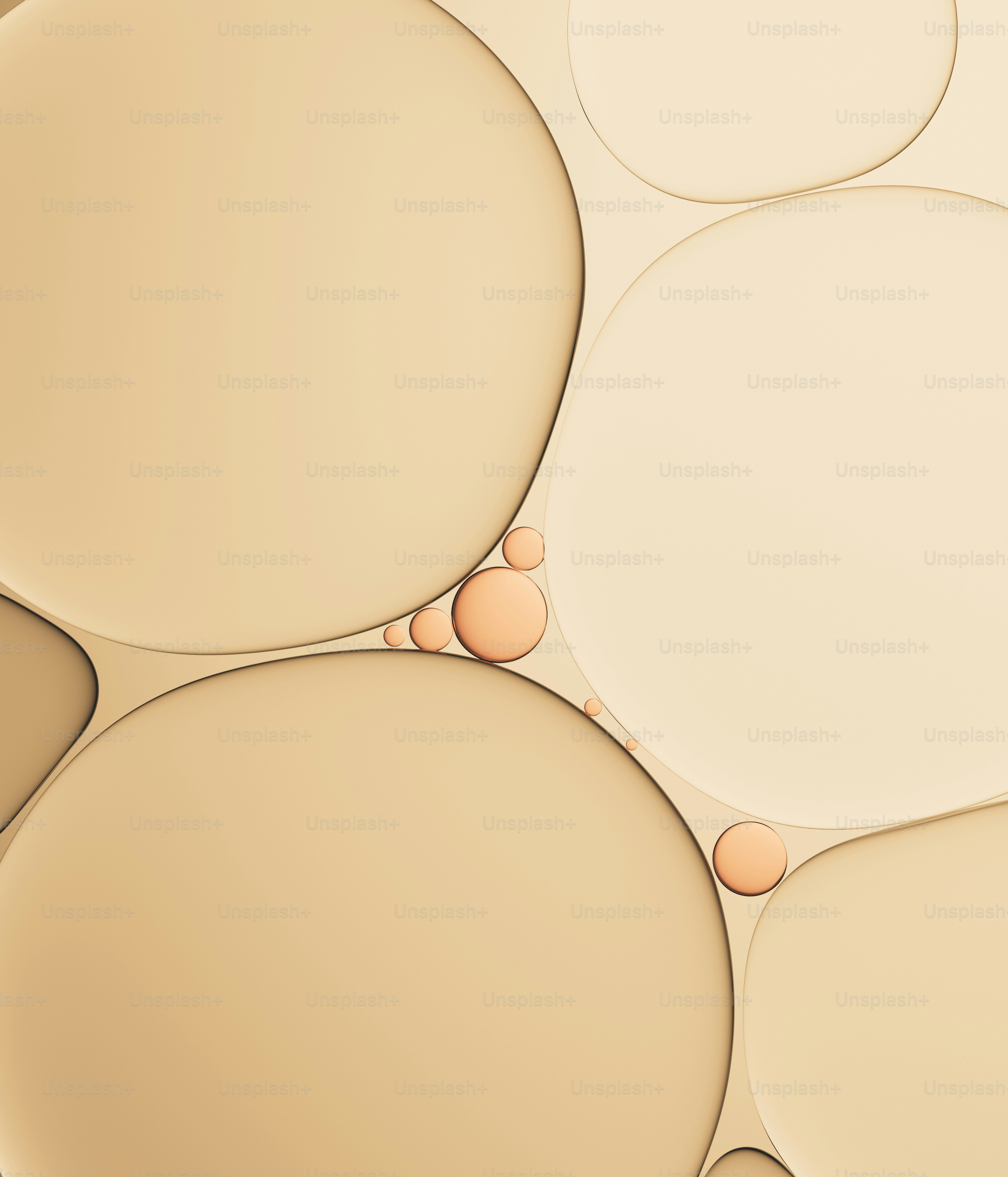 Close-up of golden oil bubbles on a light background.