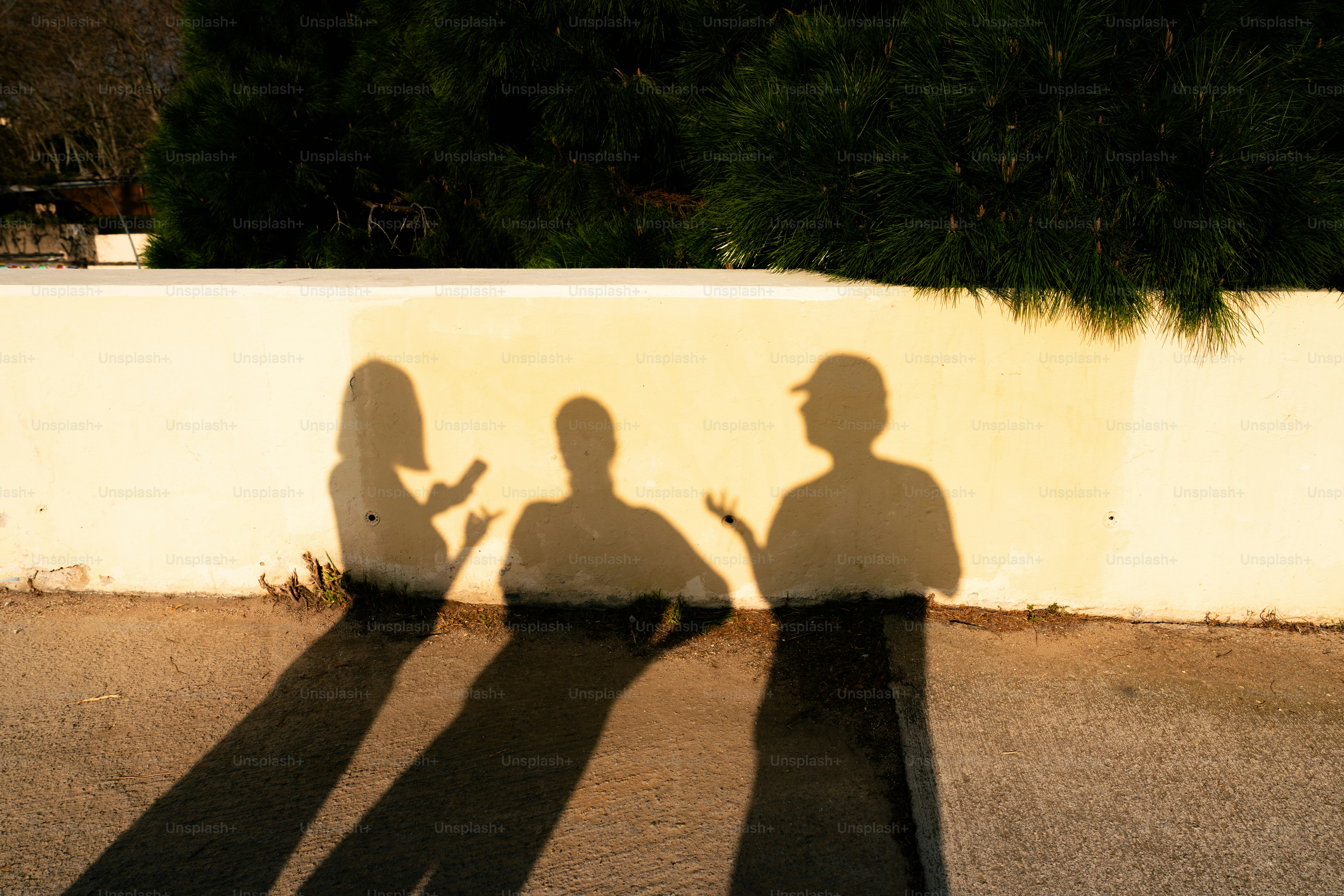 Shadows of three people on a paved surface. photo – Abstract Image on ...