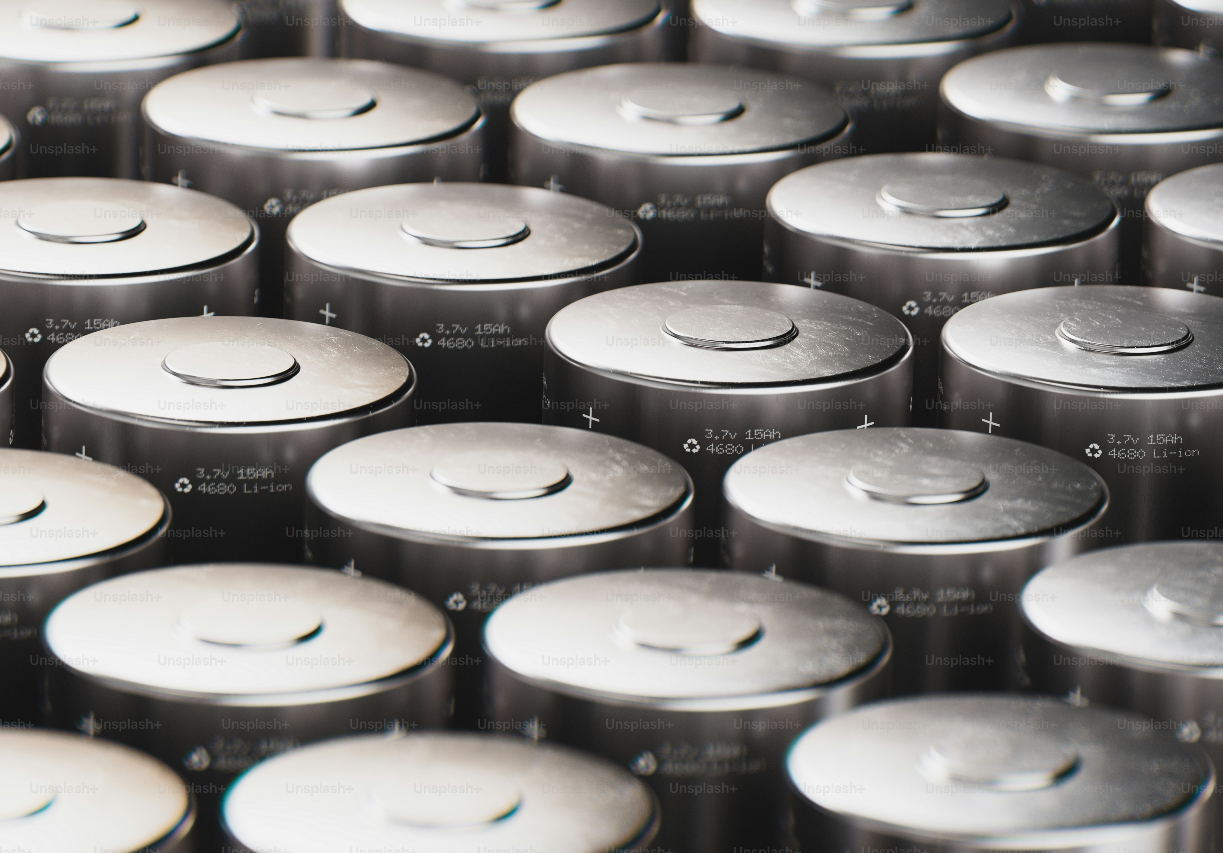 Rows of silver cylindrical batteries arranged closely together. photo ...