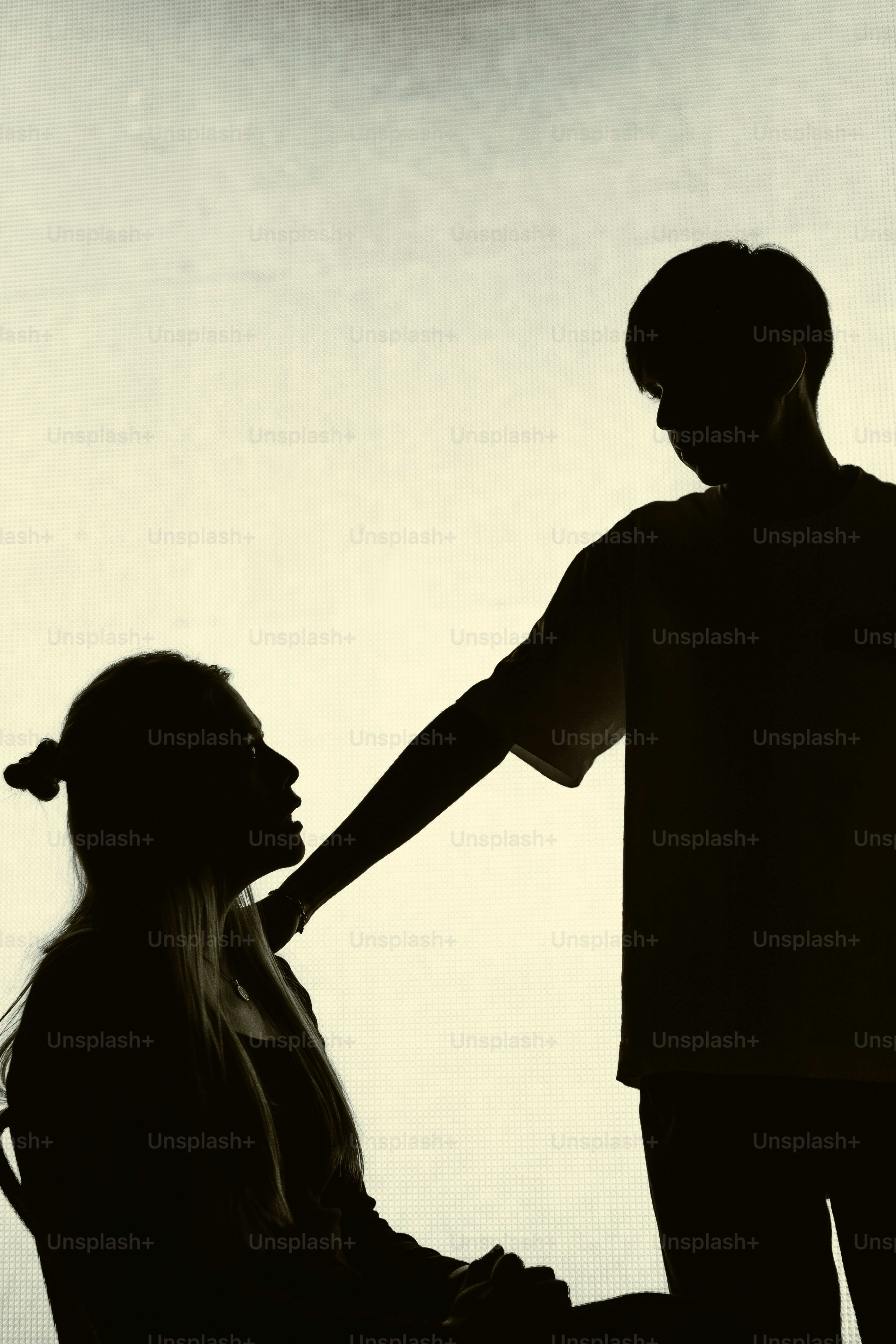 Silhouettes of a couple looking at each other