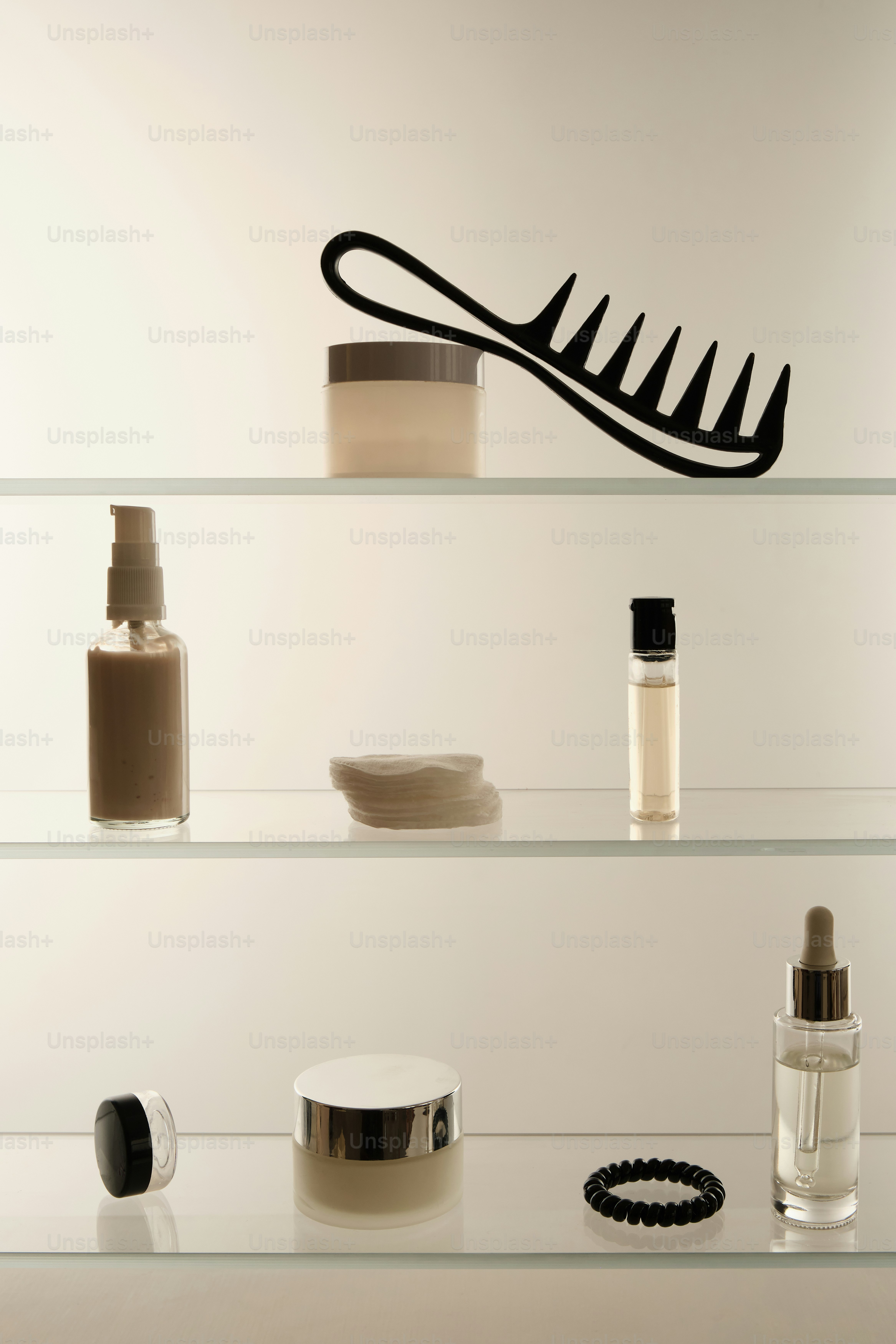 glass shelf with toiletries and everyday products