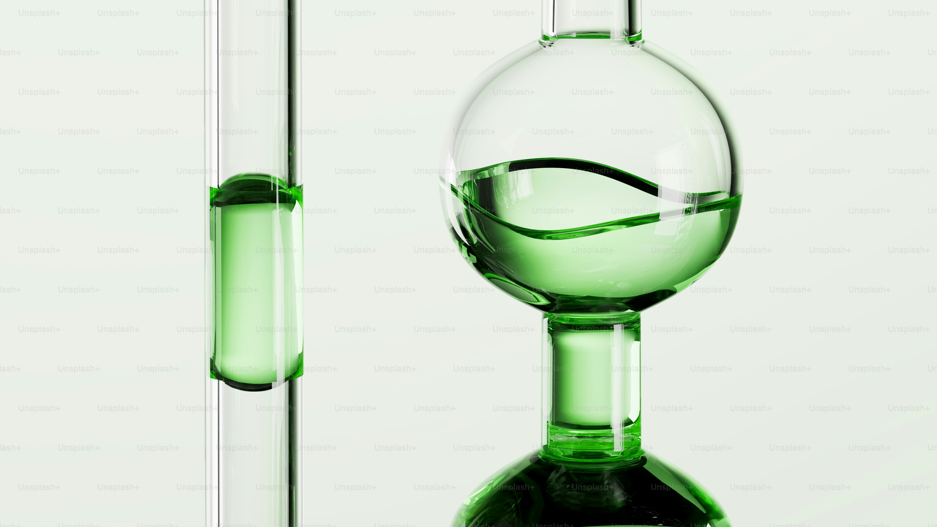 Dua instrumen kaca laboratorium dengan cairan hijau