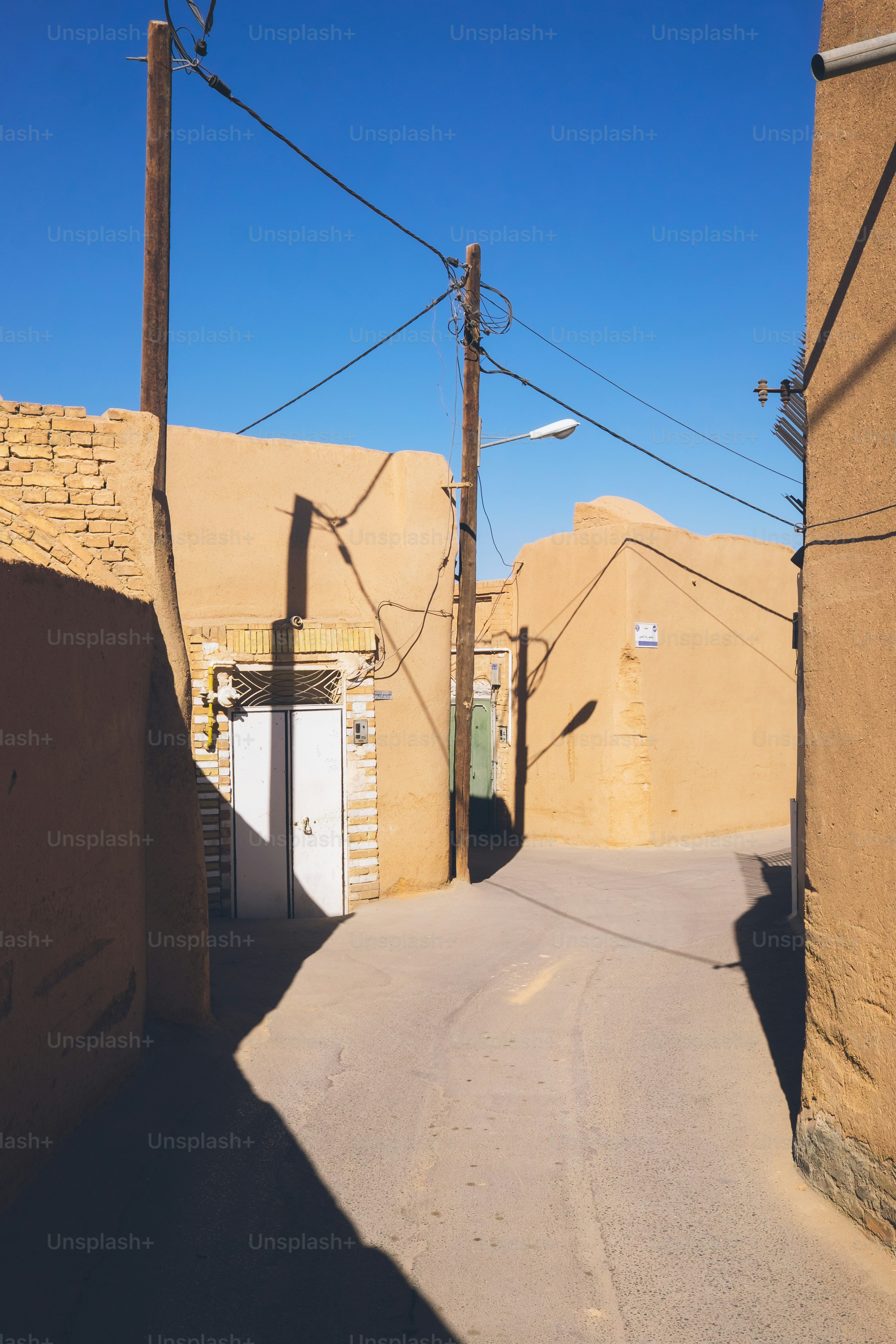 Narrow desert alley with clay buildings and brick buildings