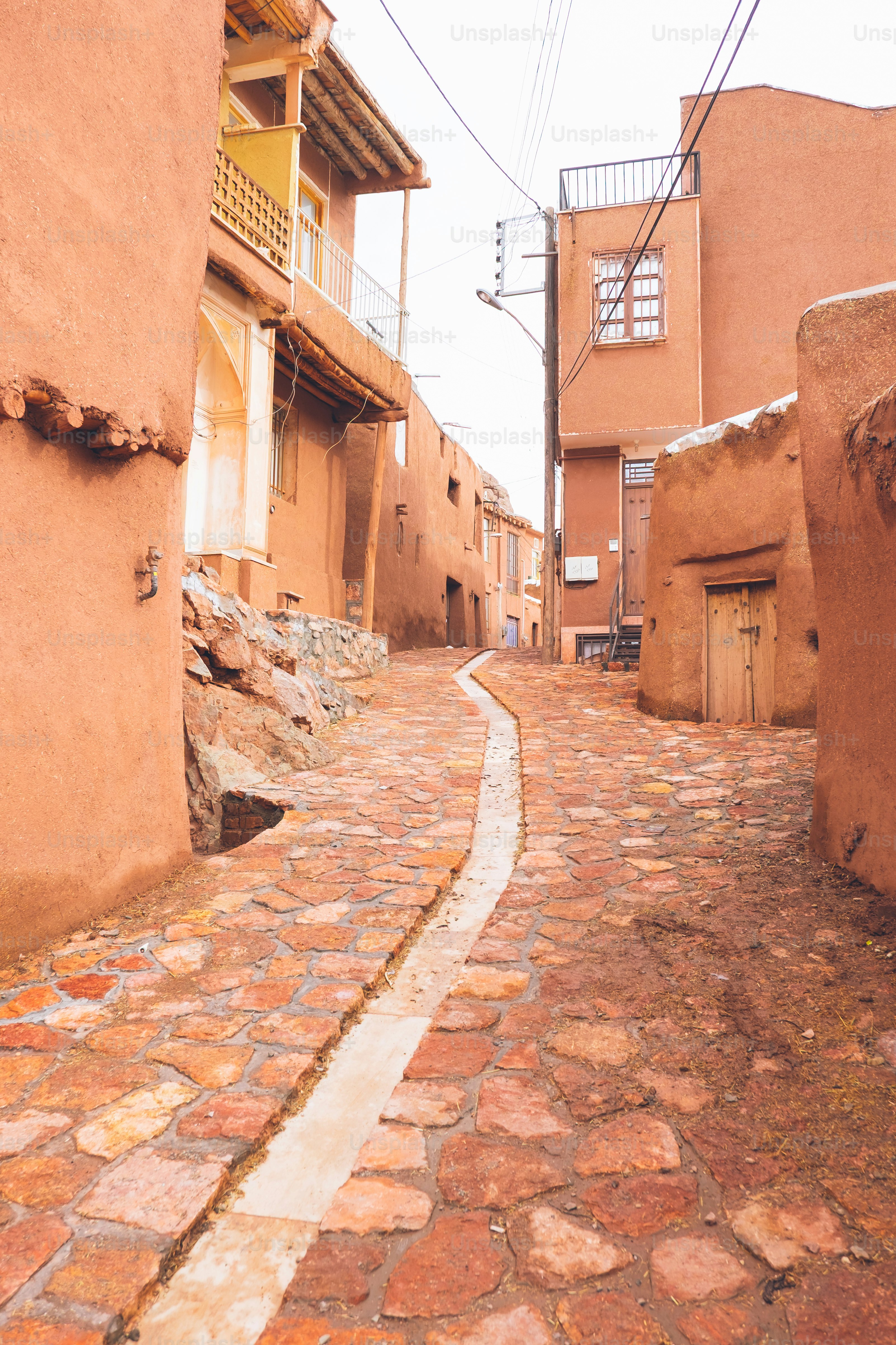 A narrow cobblestone street in an ancient village