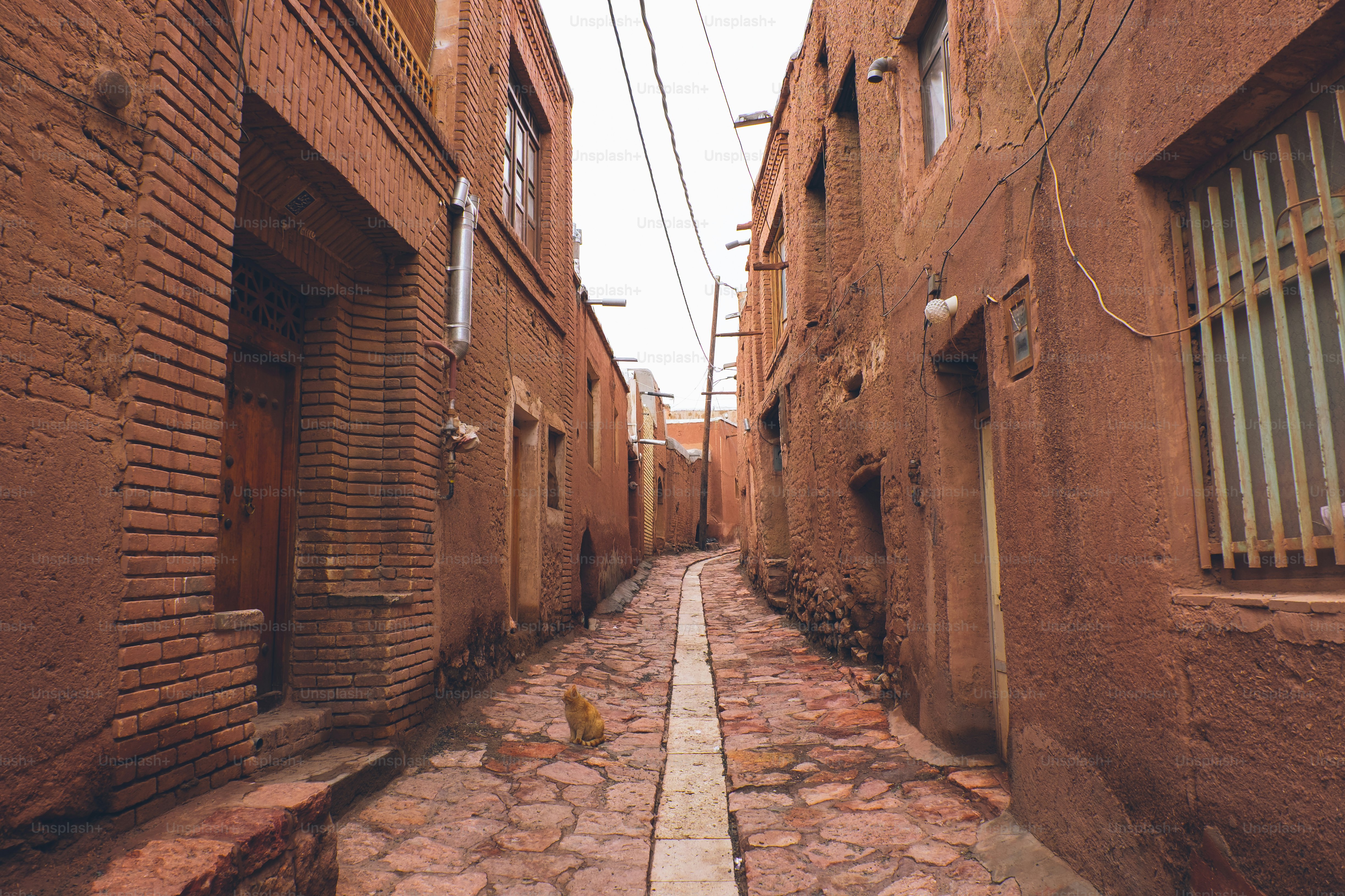 Narrow alleyway between old clay buildings