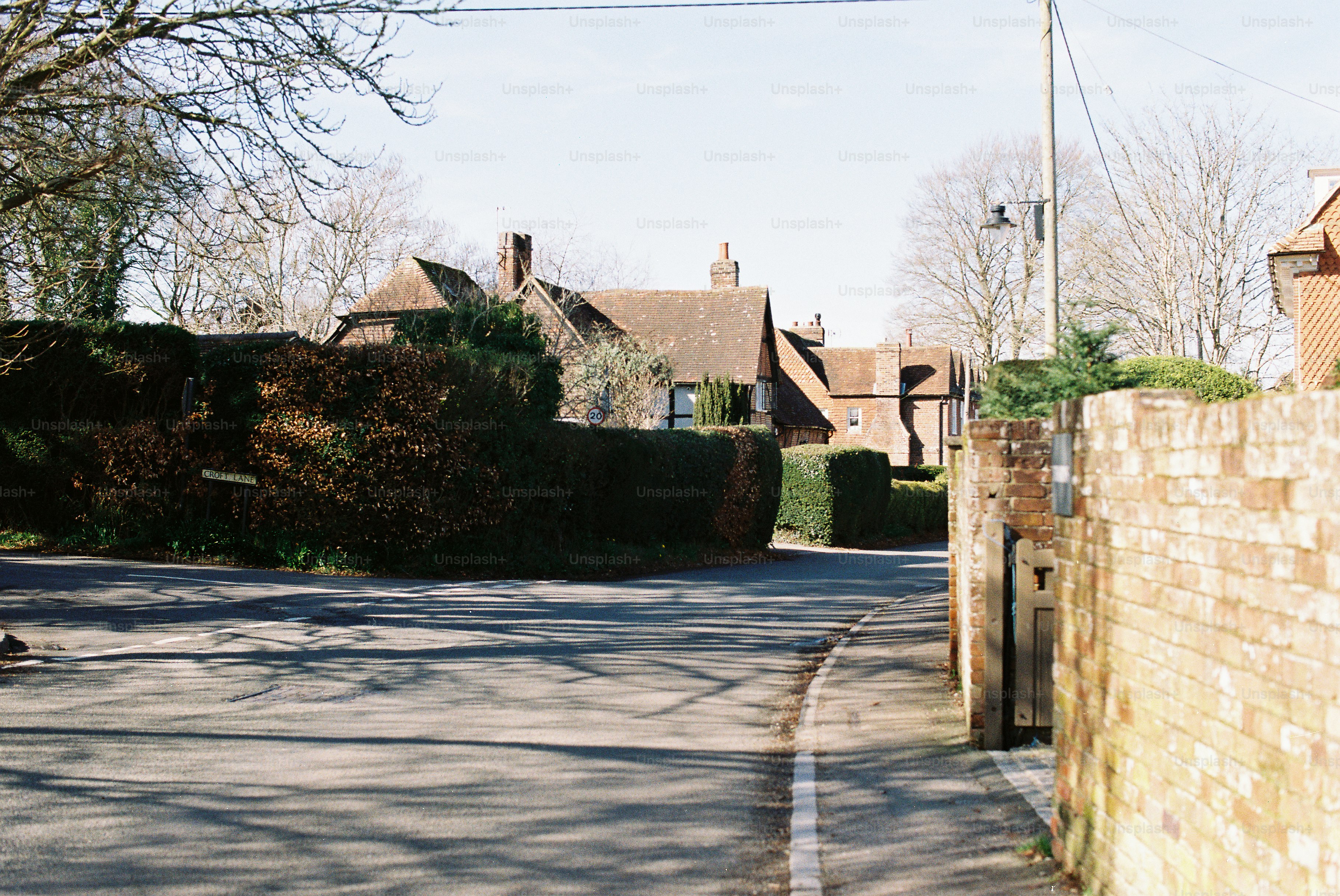 A quiet street with brick walls and houses.