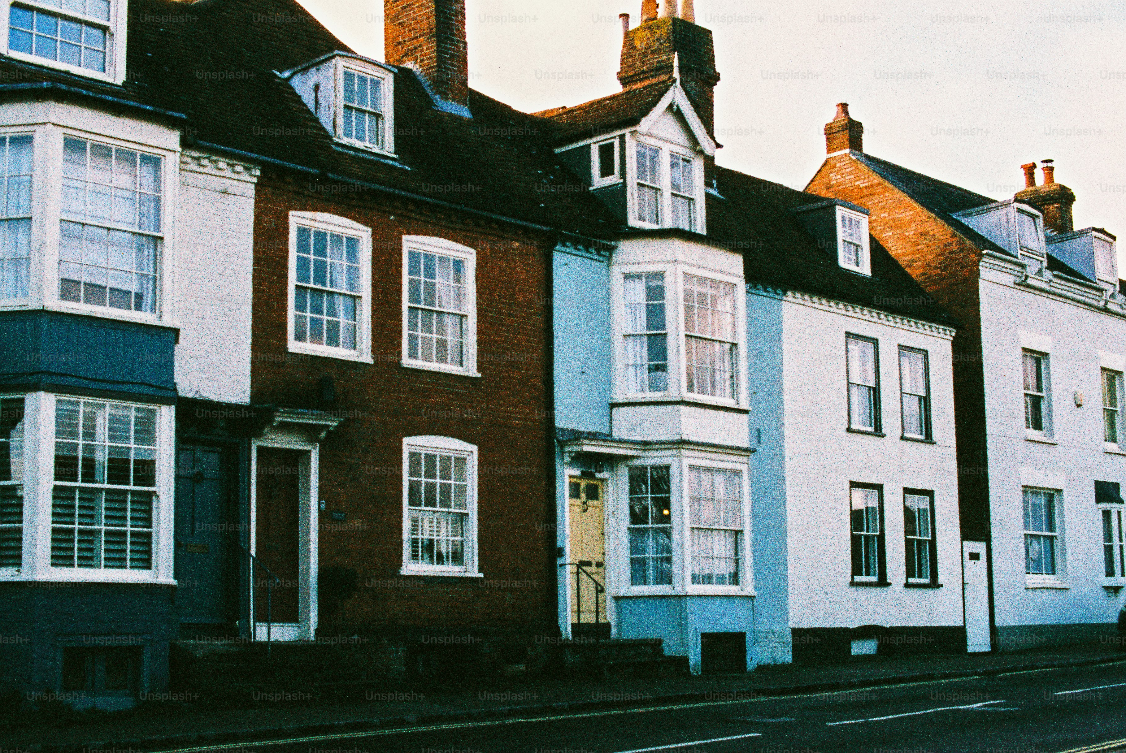 Row of colorful terraced houses on a street.