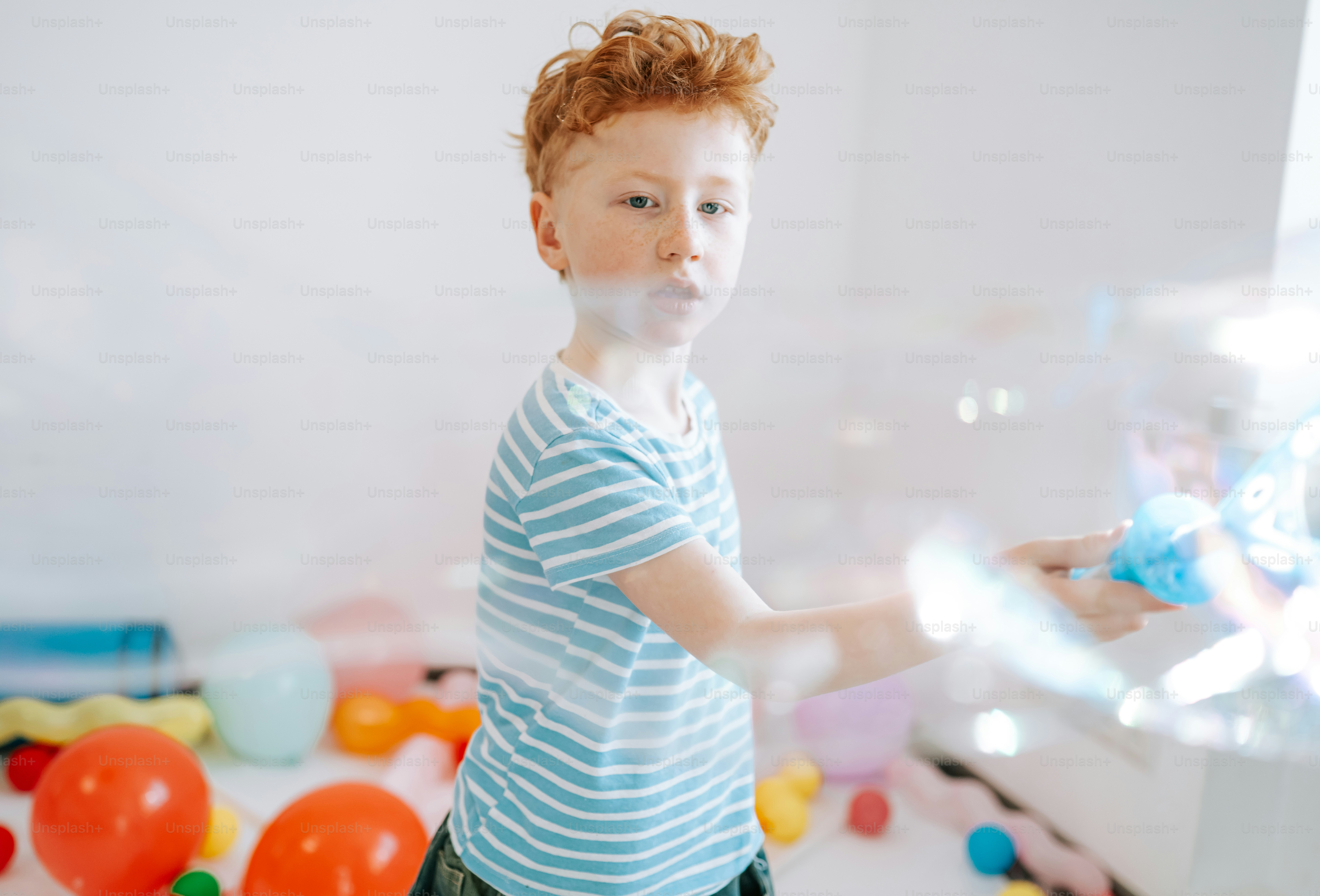 Young boy blowing bubbles with a bubble wand