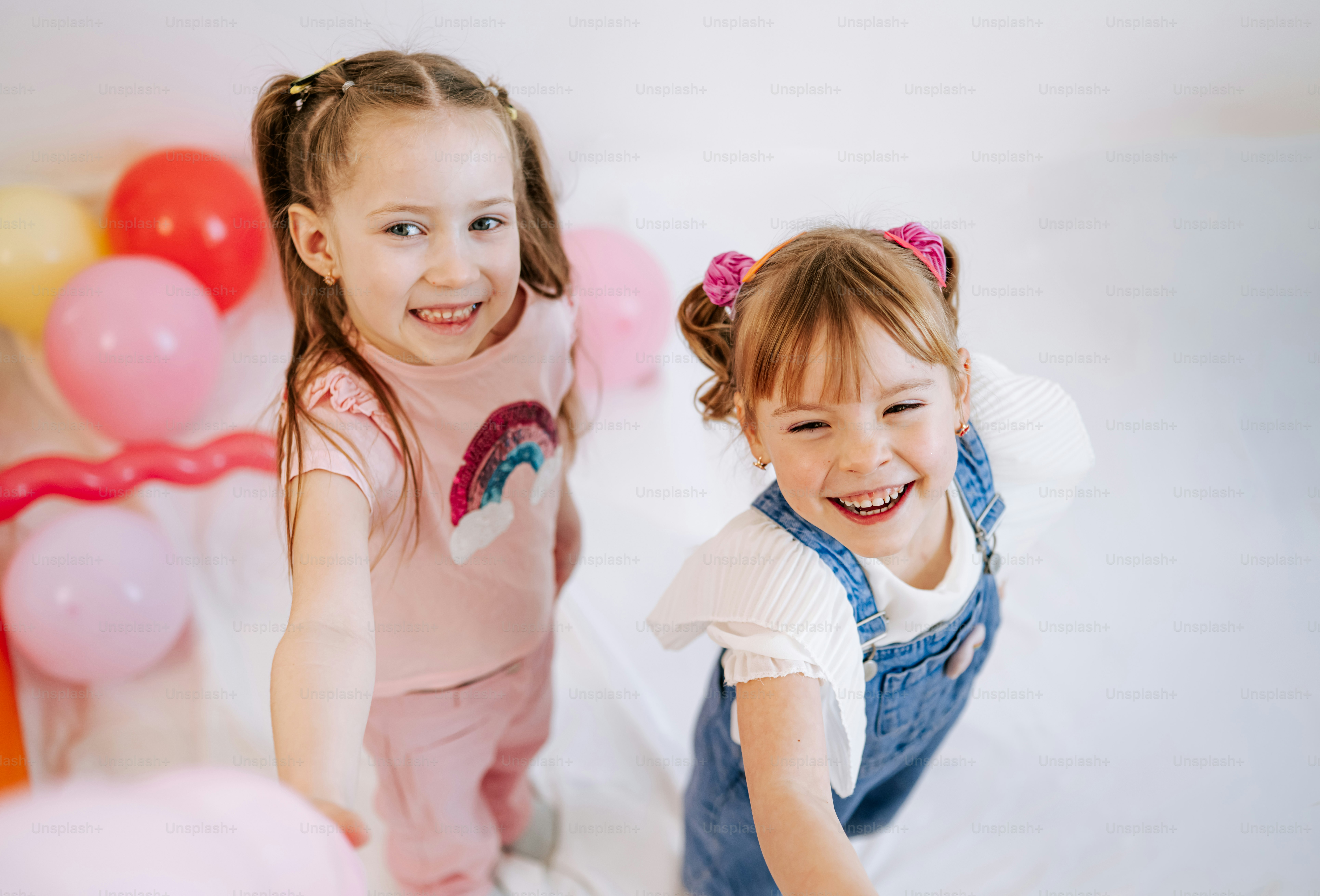 Two happy young girls with balloons photo – Kids Image on Unsplash