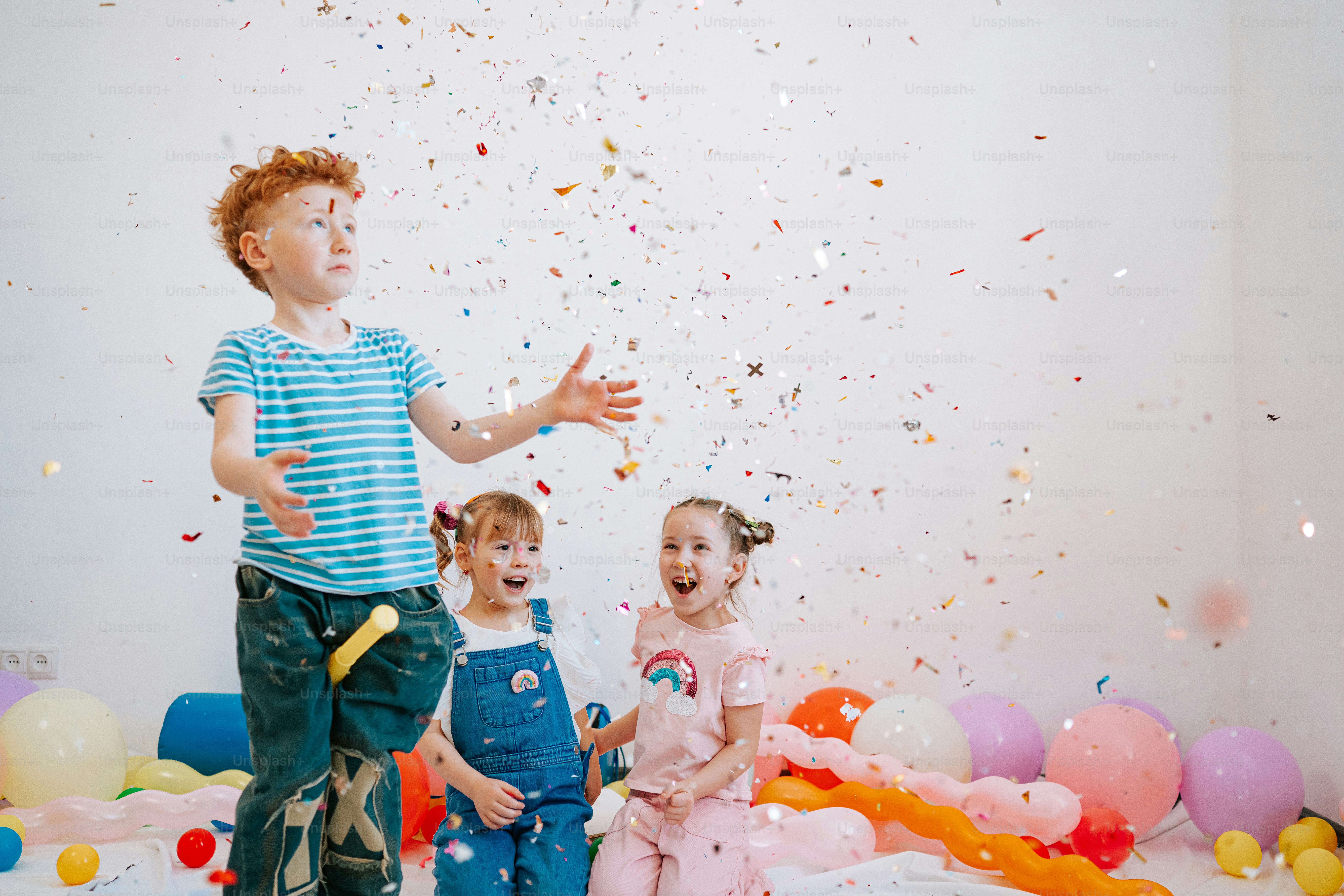 Children celebrating with confetti and balloons