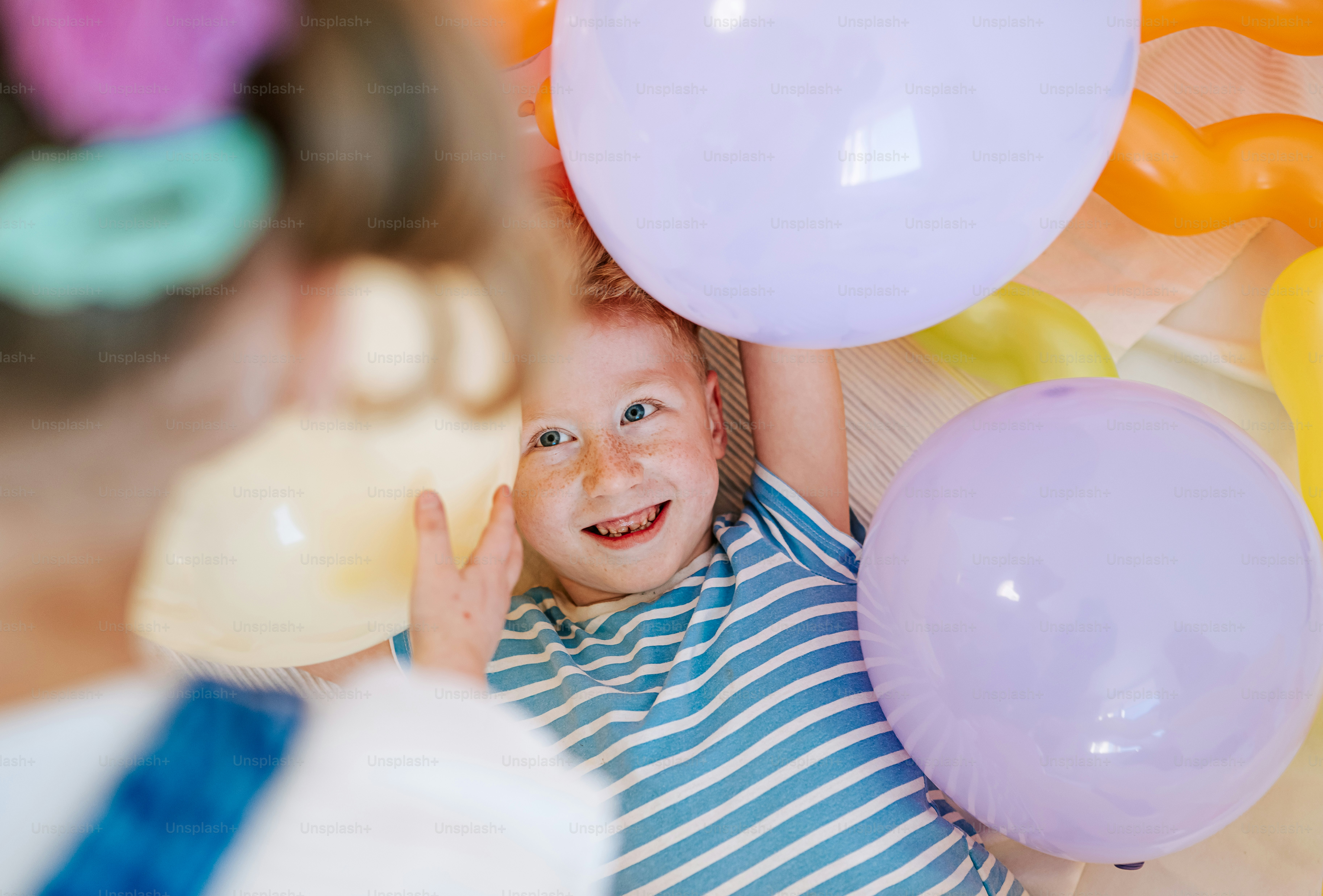 Smiling child with balloons at a party