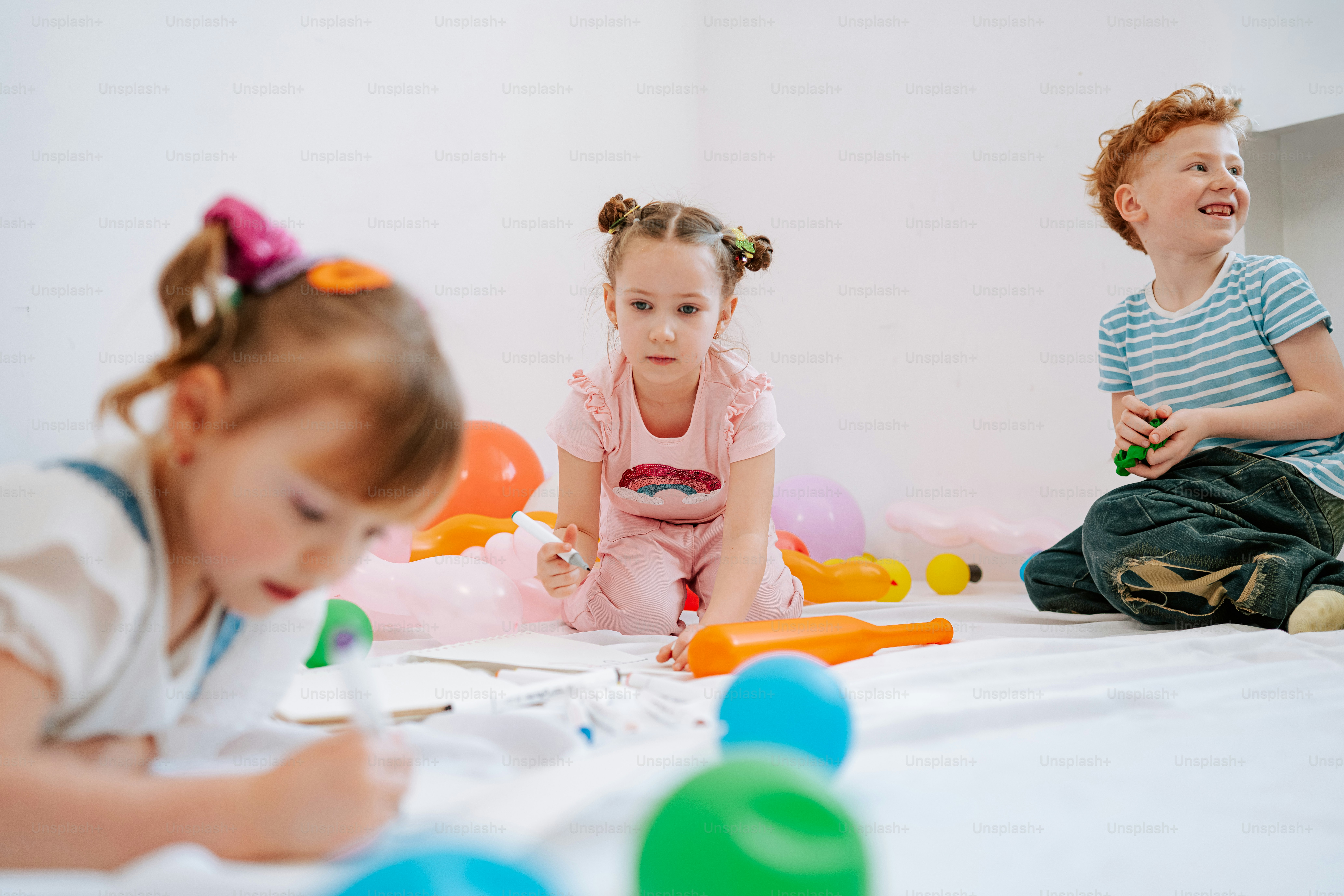 Children playing and drawing on the floor