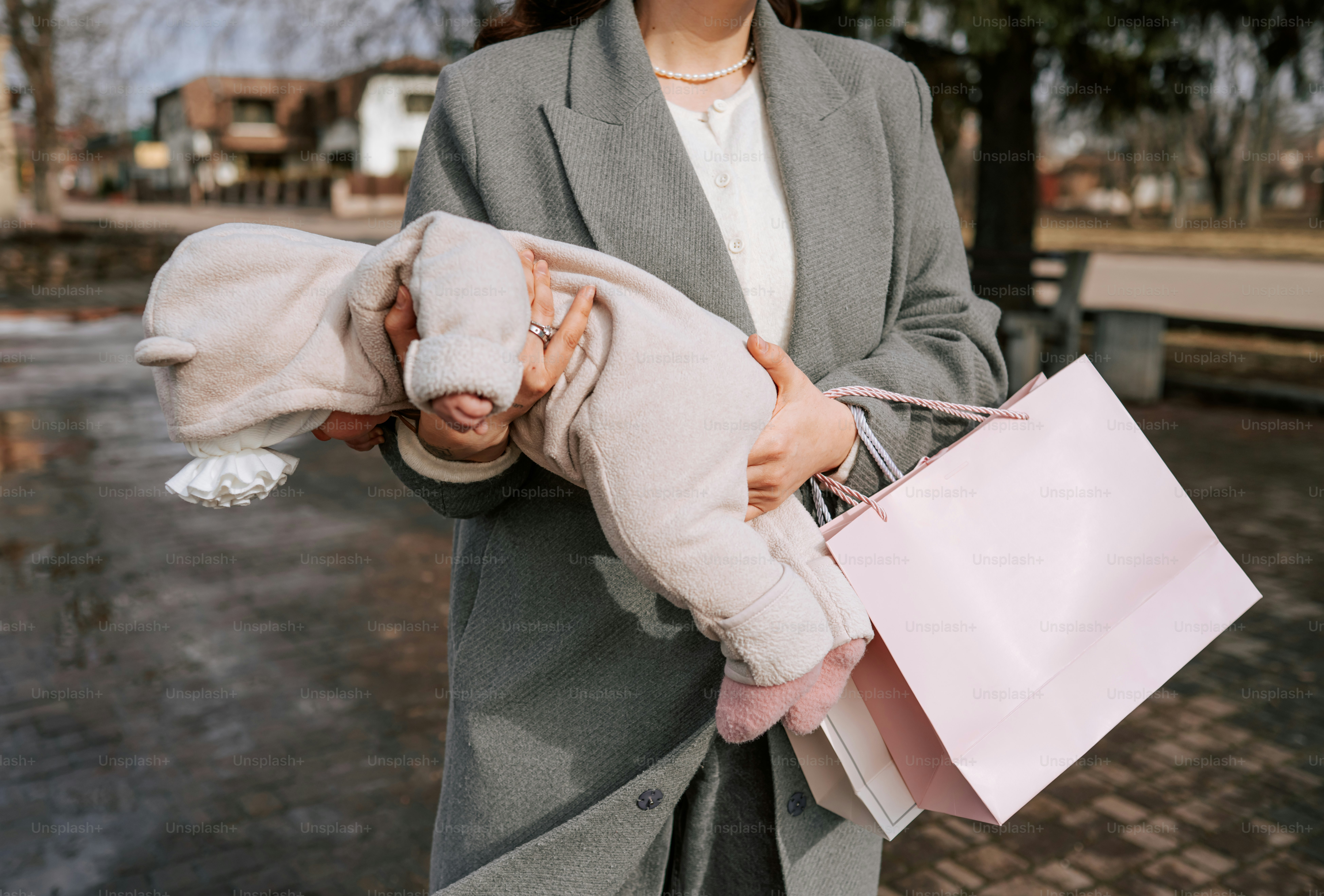 Woman holding a baby and shopping bags