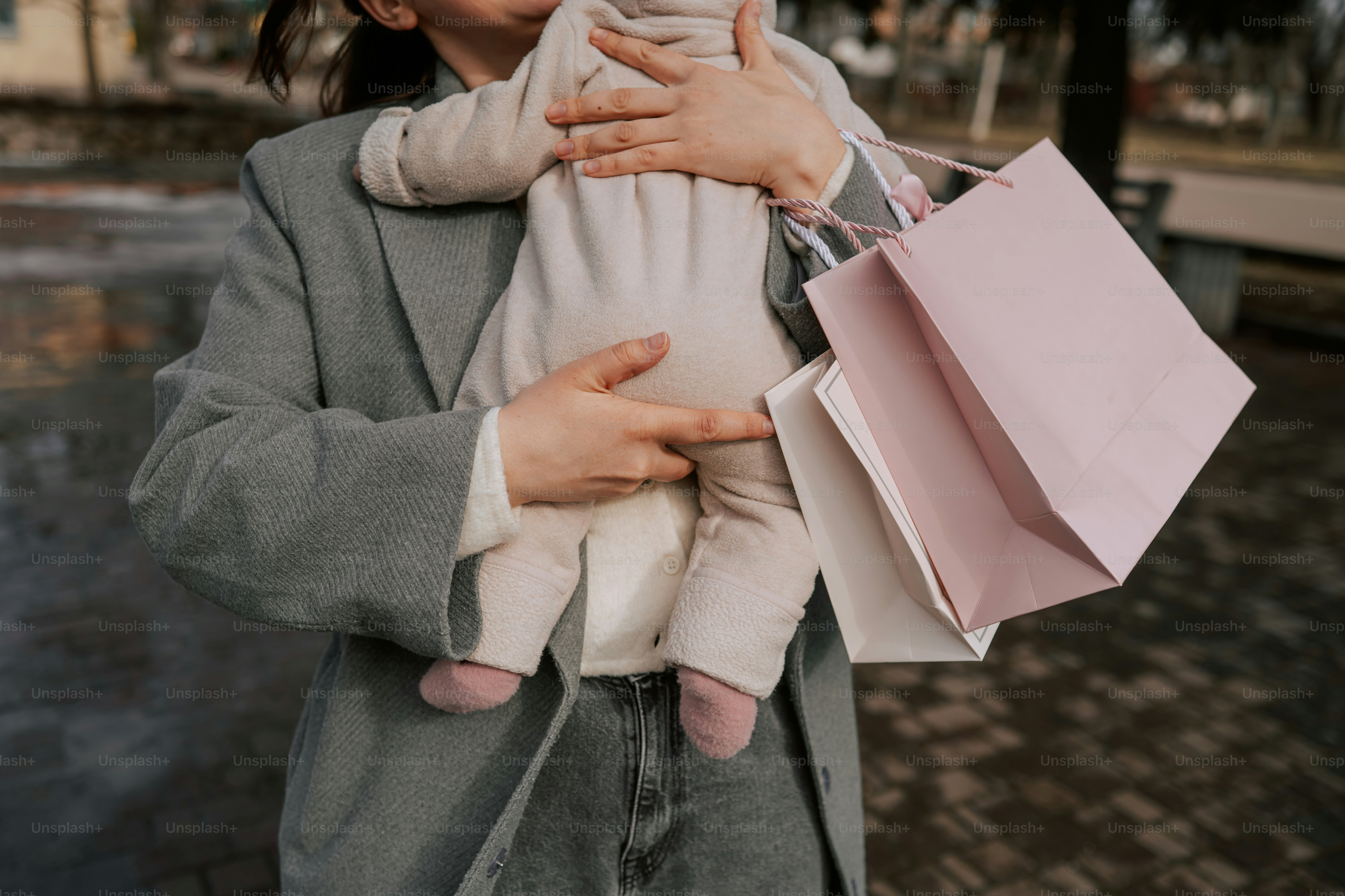 Woman holding baby with shopping bags
