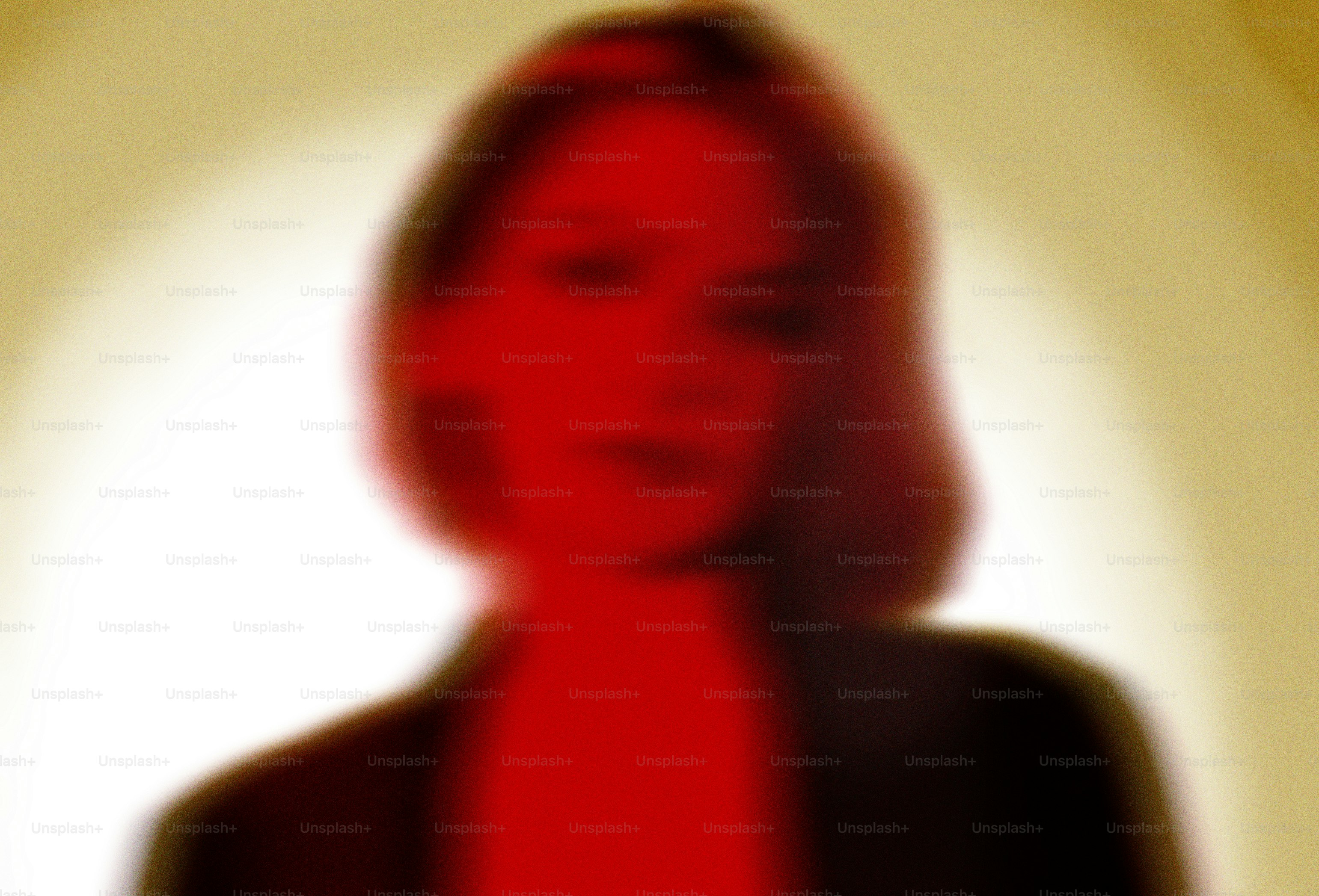Blurred portrait of a woman in red and red light.