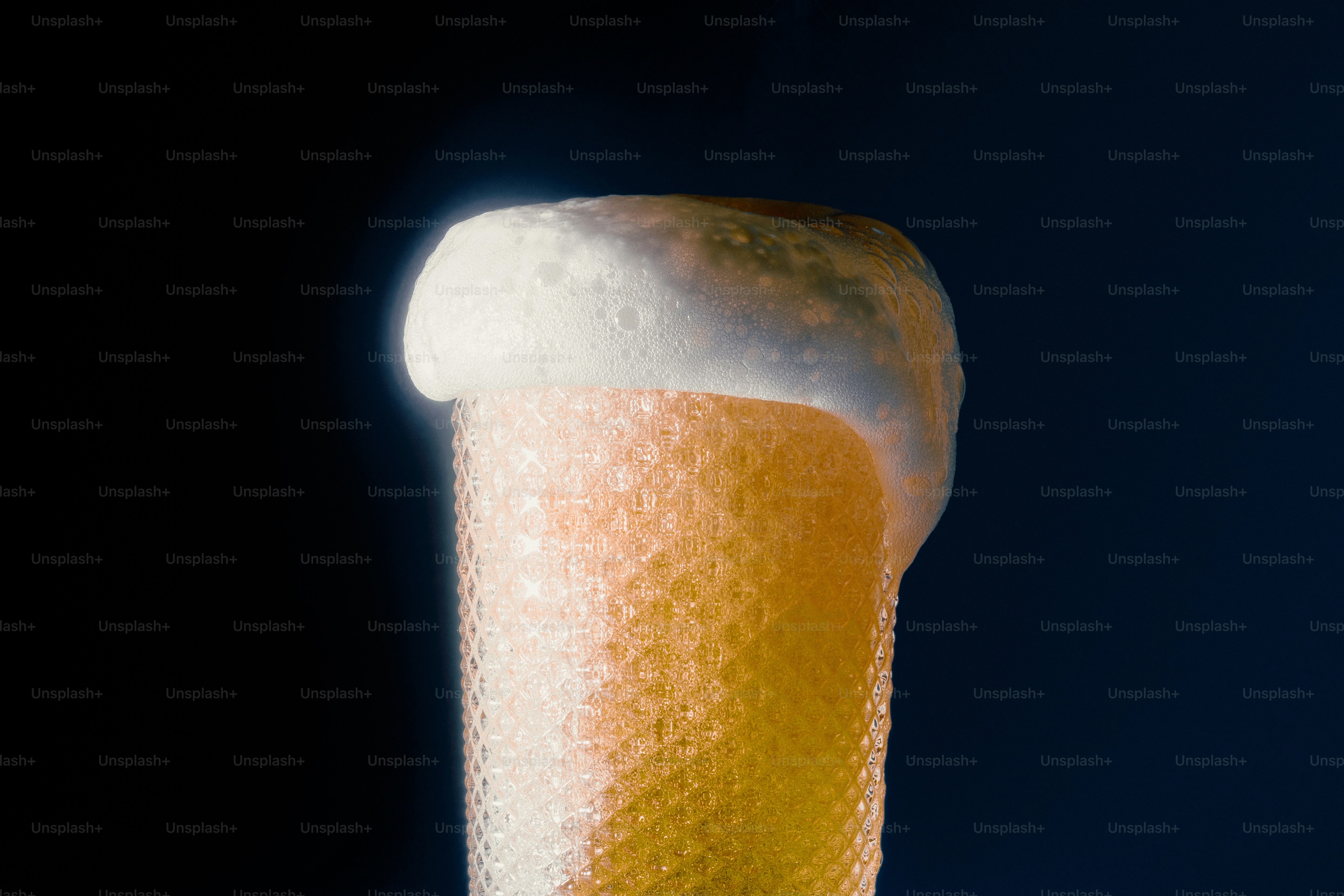 Close-up of beer foam overflowing from a glass