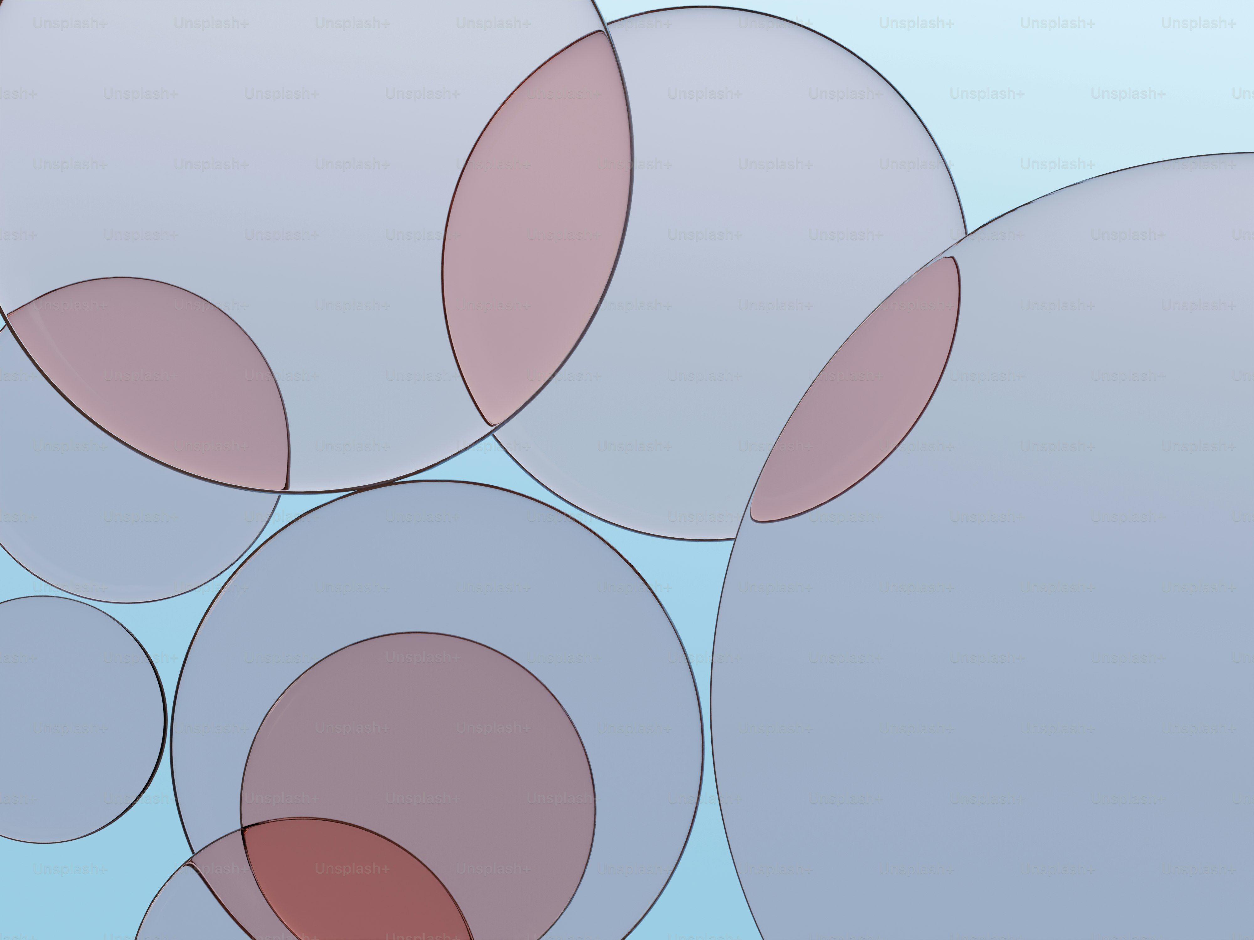 柔らかな赤と灰色の色調で重なり合う円。