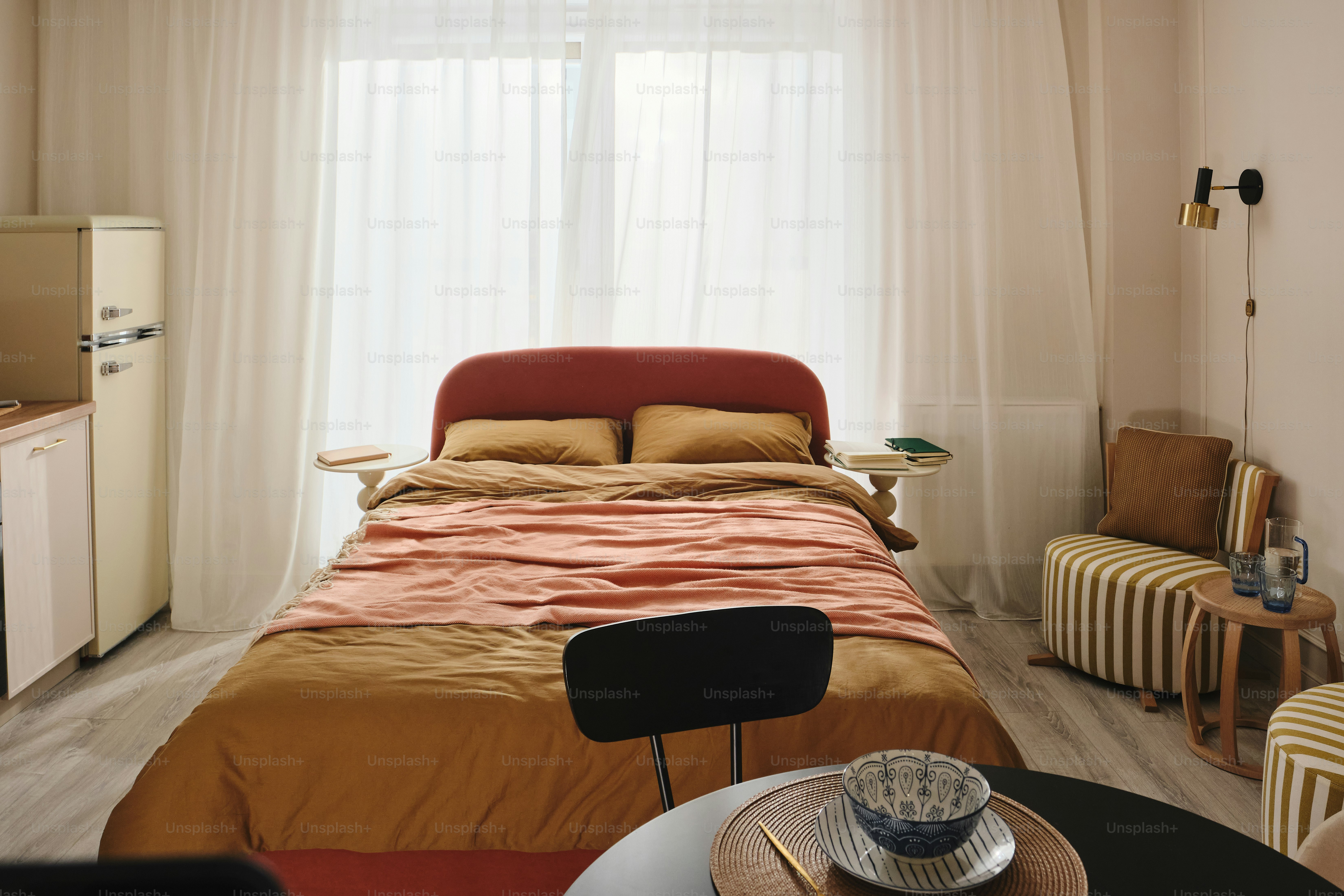 Cozy studio apartment with a bed and kitchenette.