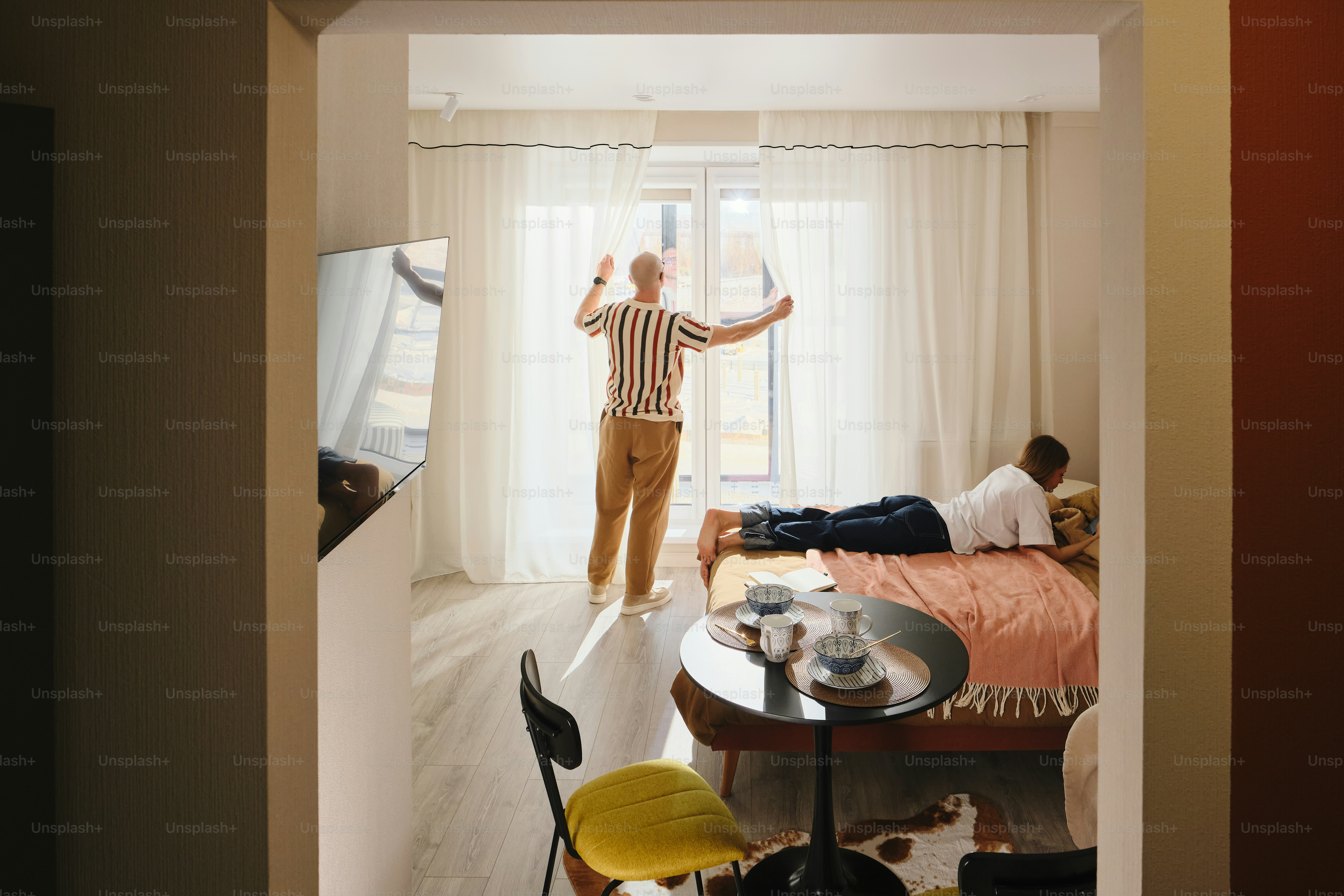 Two men in a hotel room by the window. photo – Interior design Image on ...