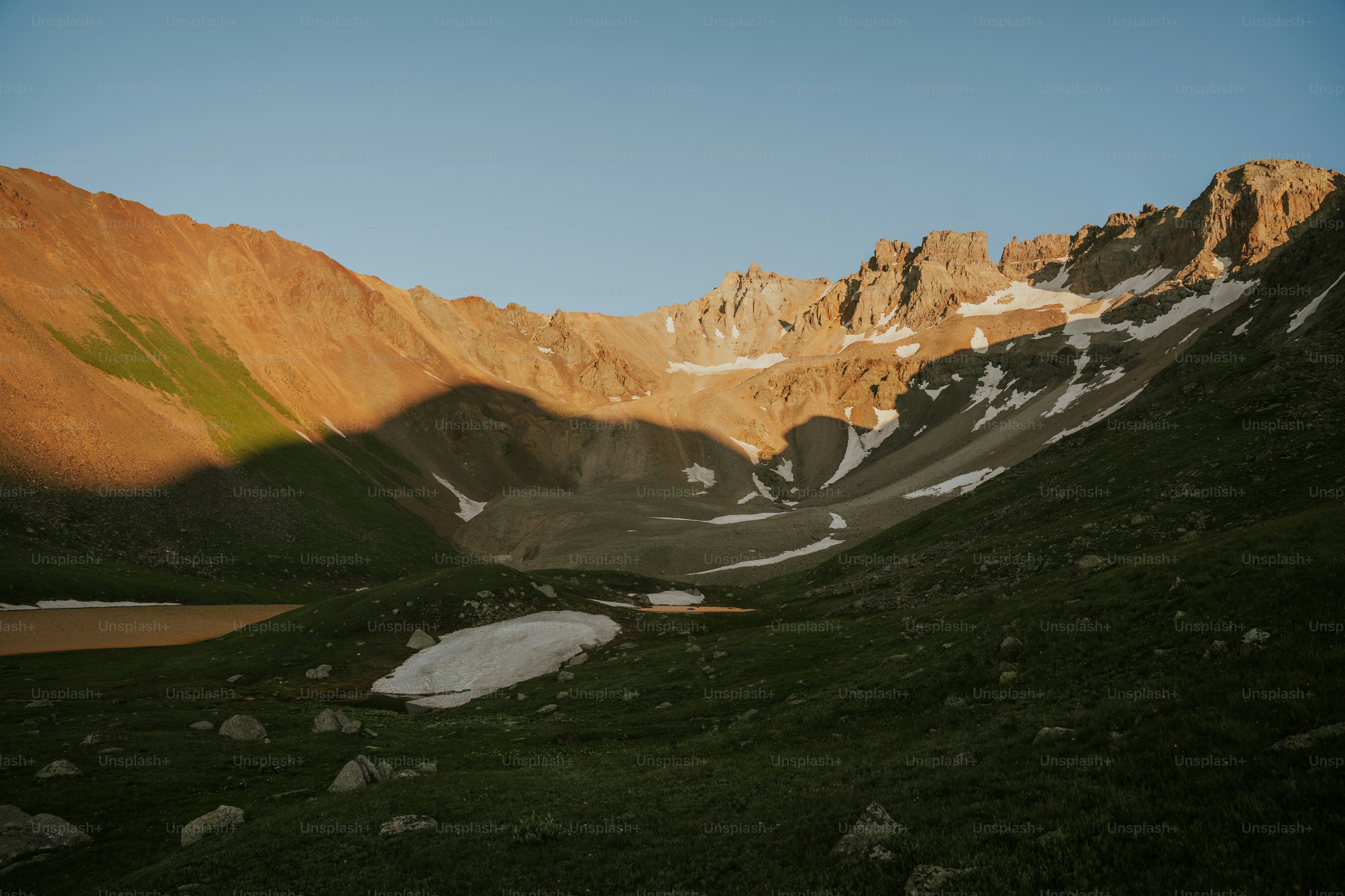 A mountain valley bathed in golden hour light.