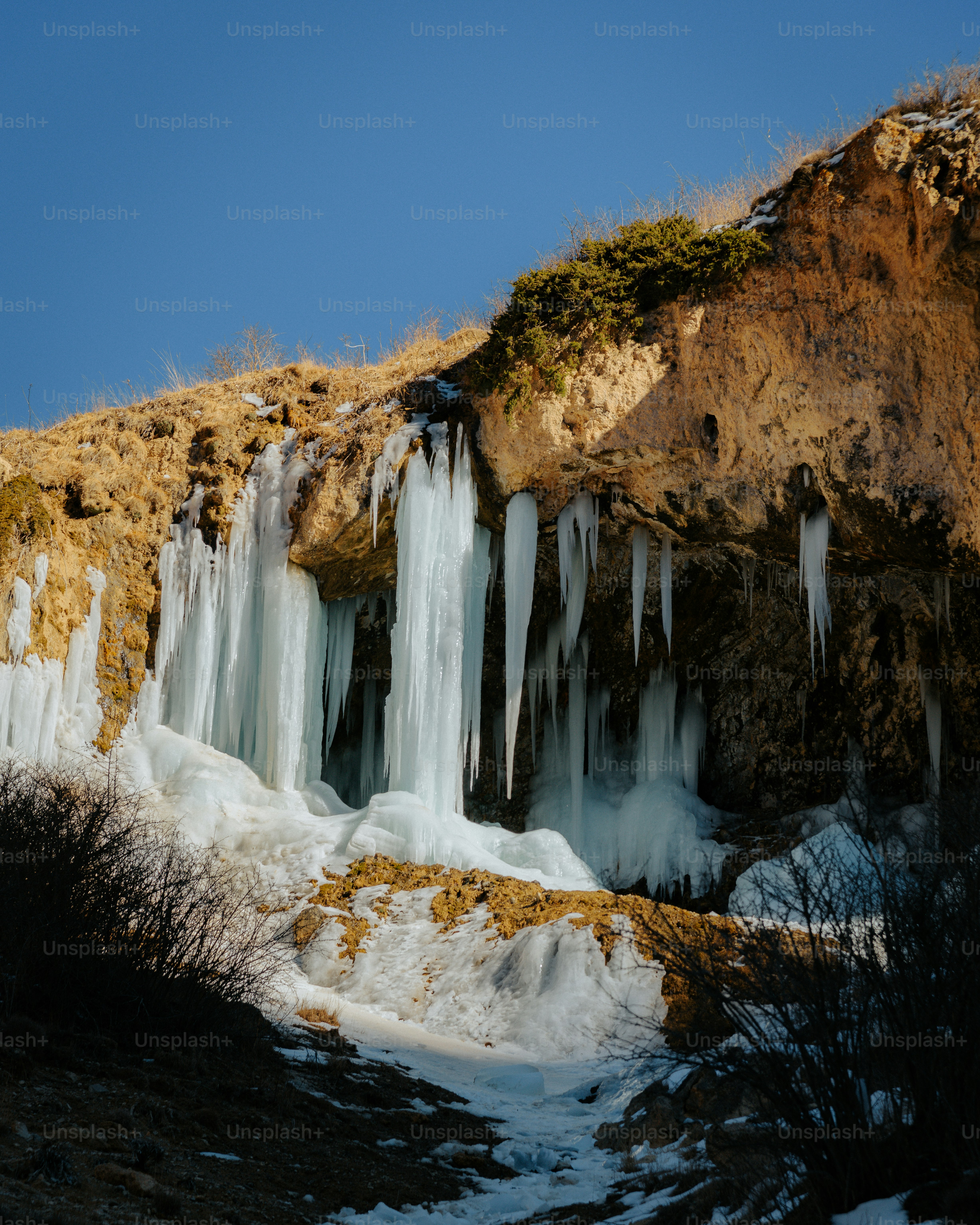 Frozen waterfall with icicles hanging from cliff