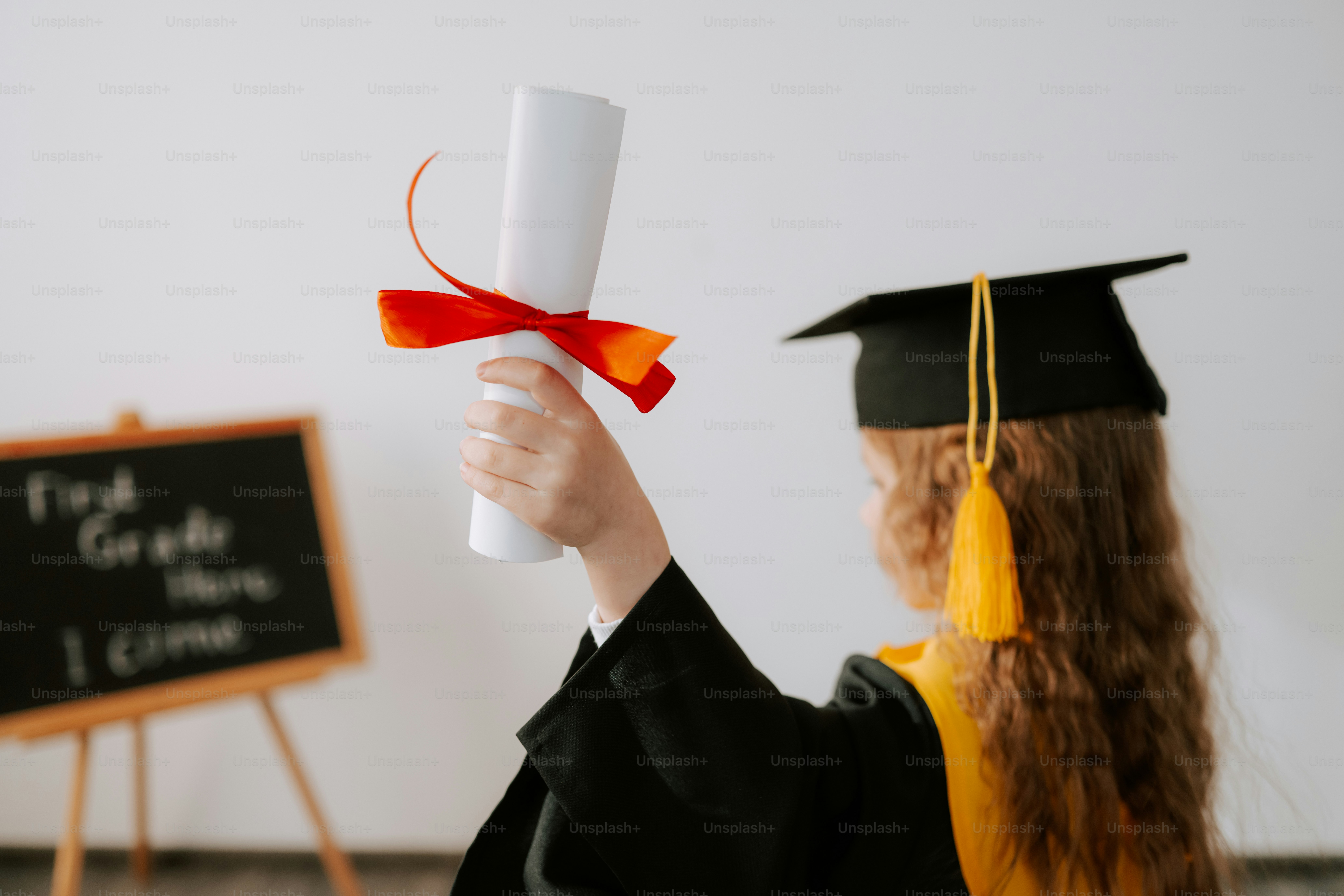 Child in graduation cap holds diploma, blackboard behind photo – School ...