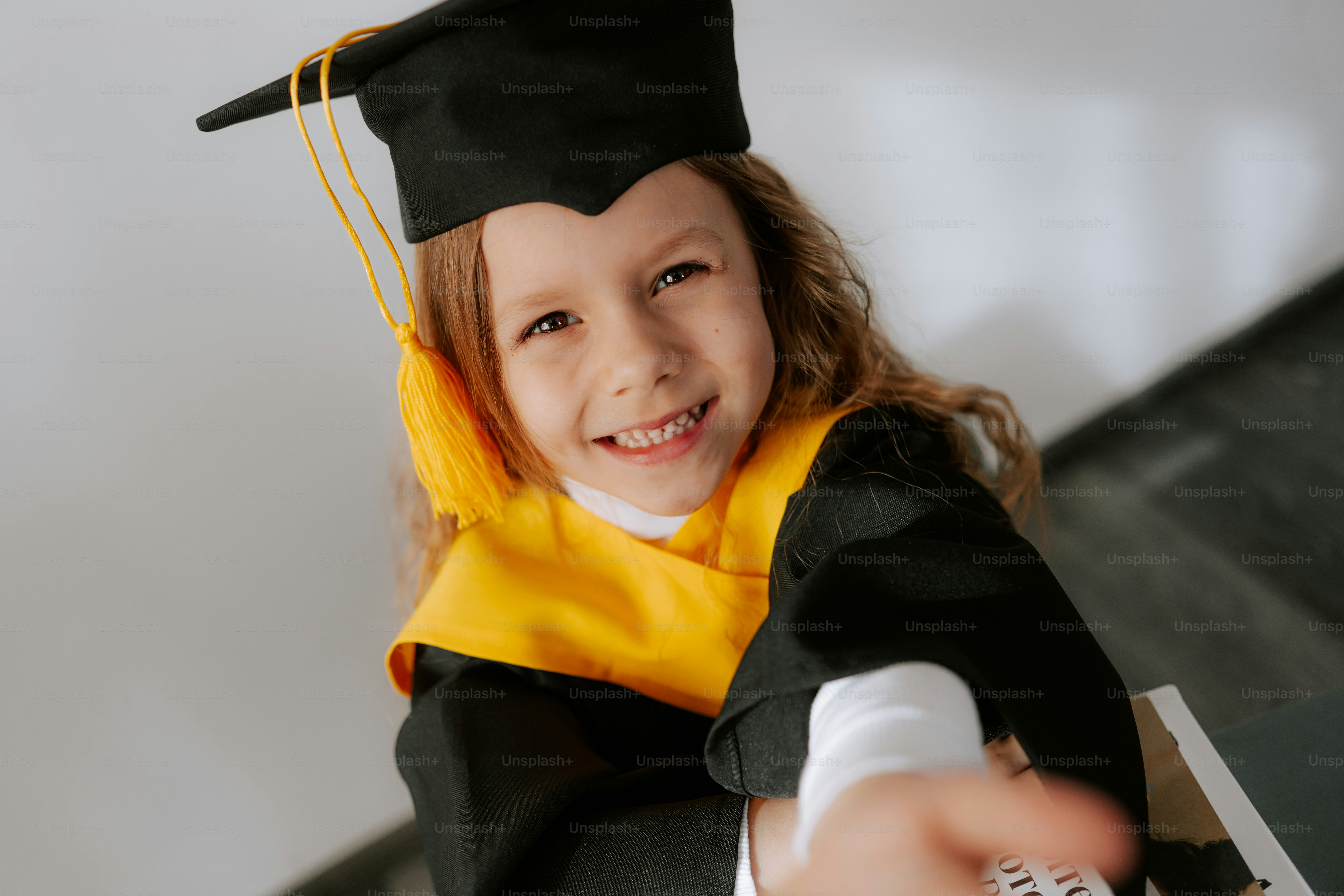 A smiling girl in a graduation cap and gown