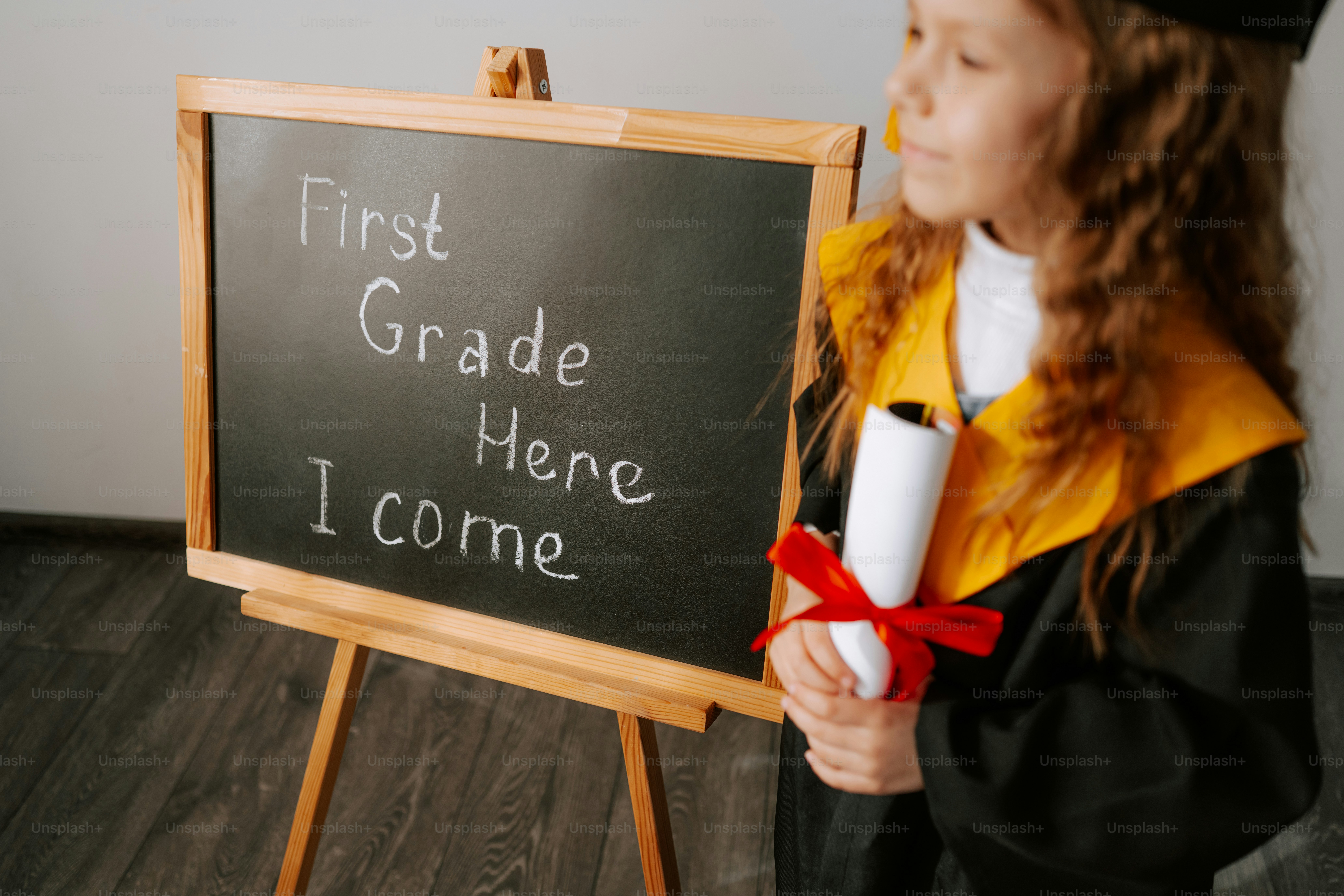 Child in graduation cap holds diploma, blackboard behind photo – School ...