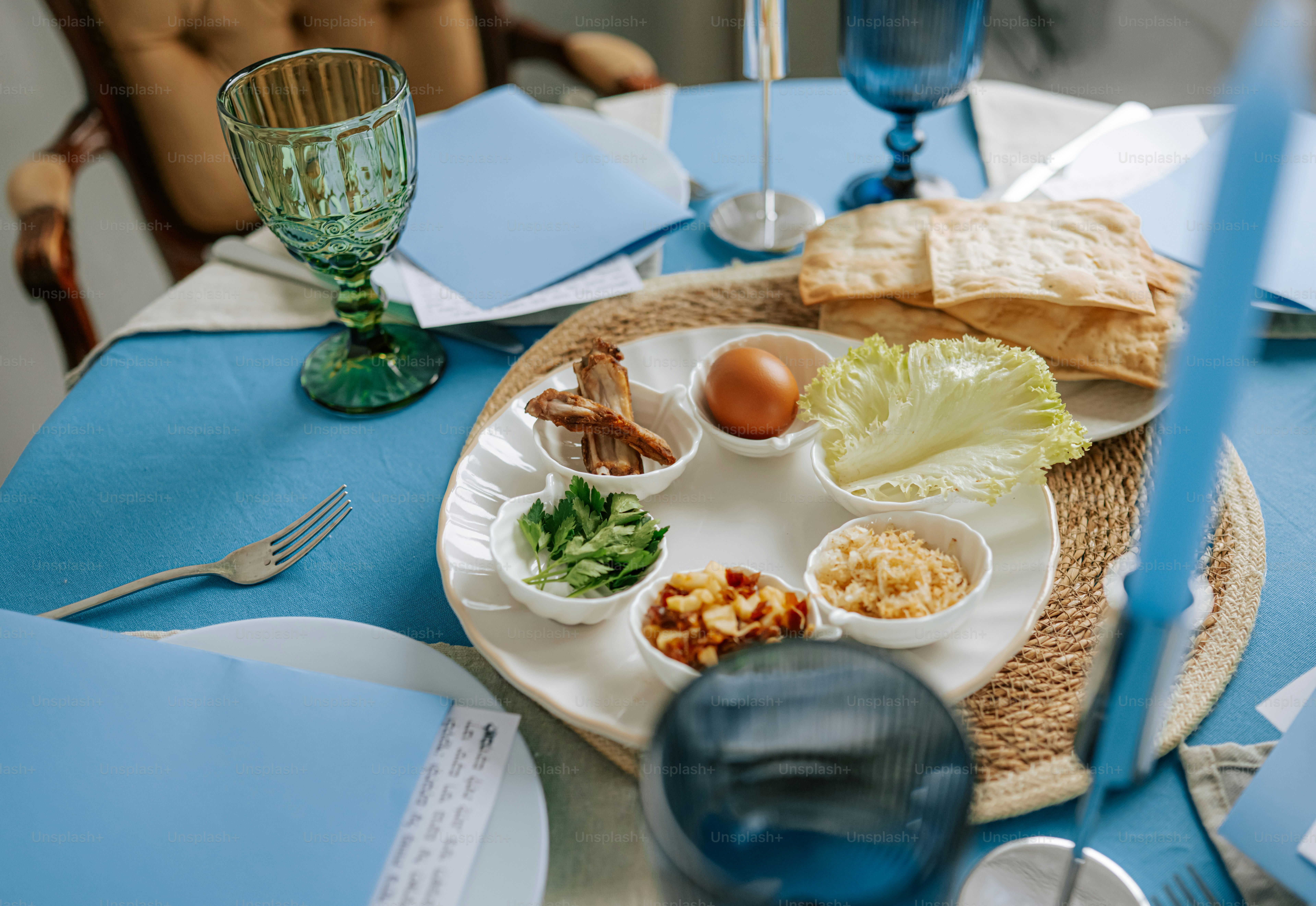 Seder plate with matzah and wine glass of a book photo – Passover Image ...