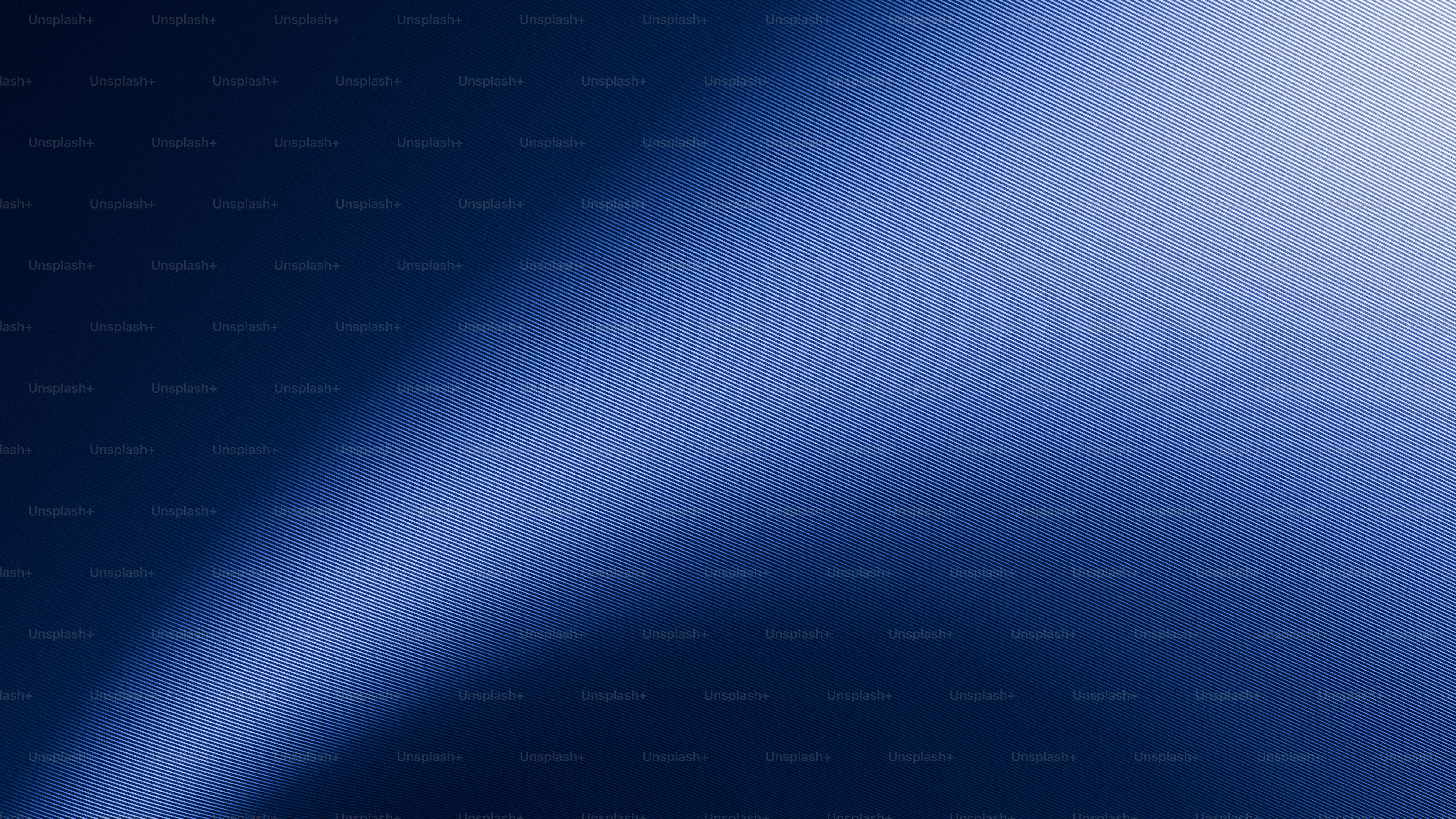 Abstract blue gradient with a bright light streak.