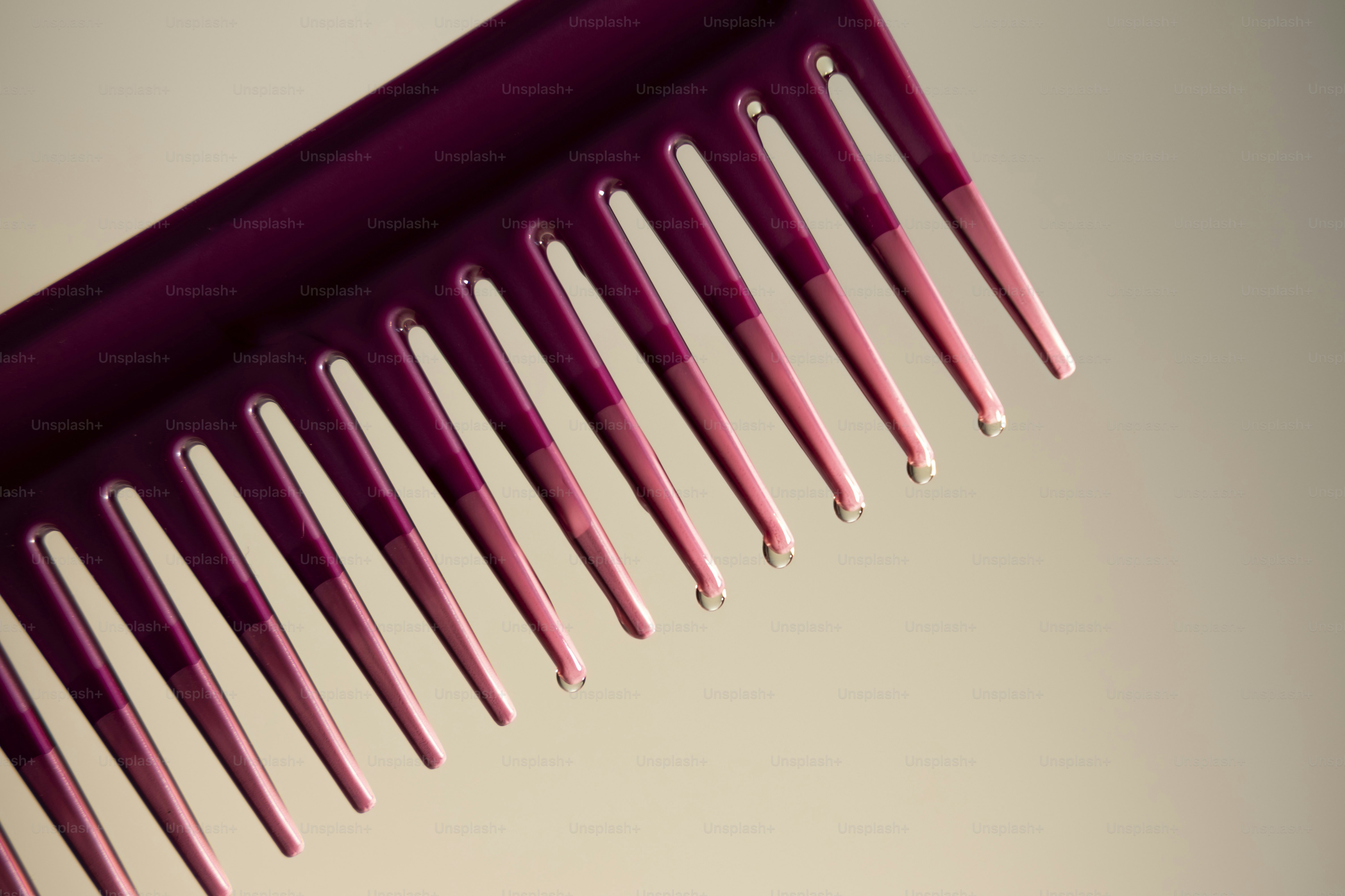 A hand combs curly brown hair with a wooden comb photo – Beauty Image ...