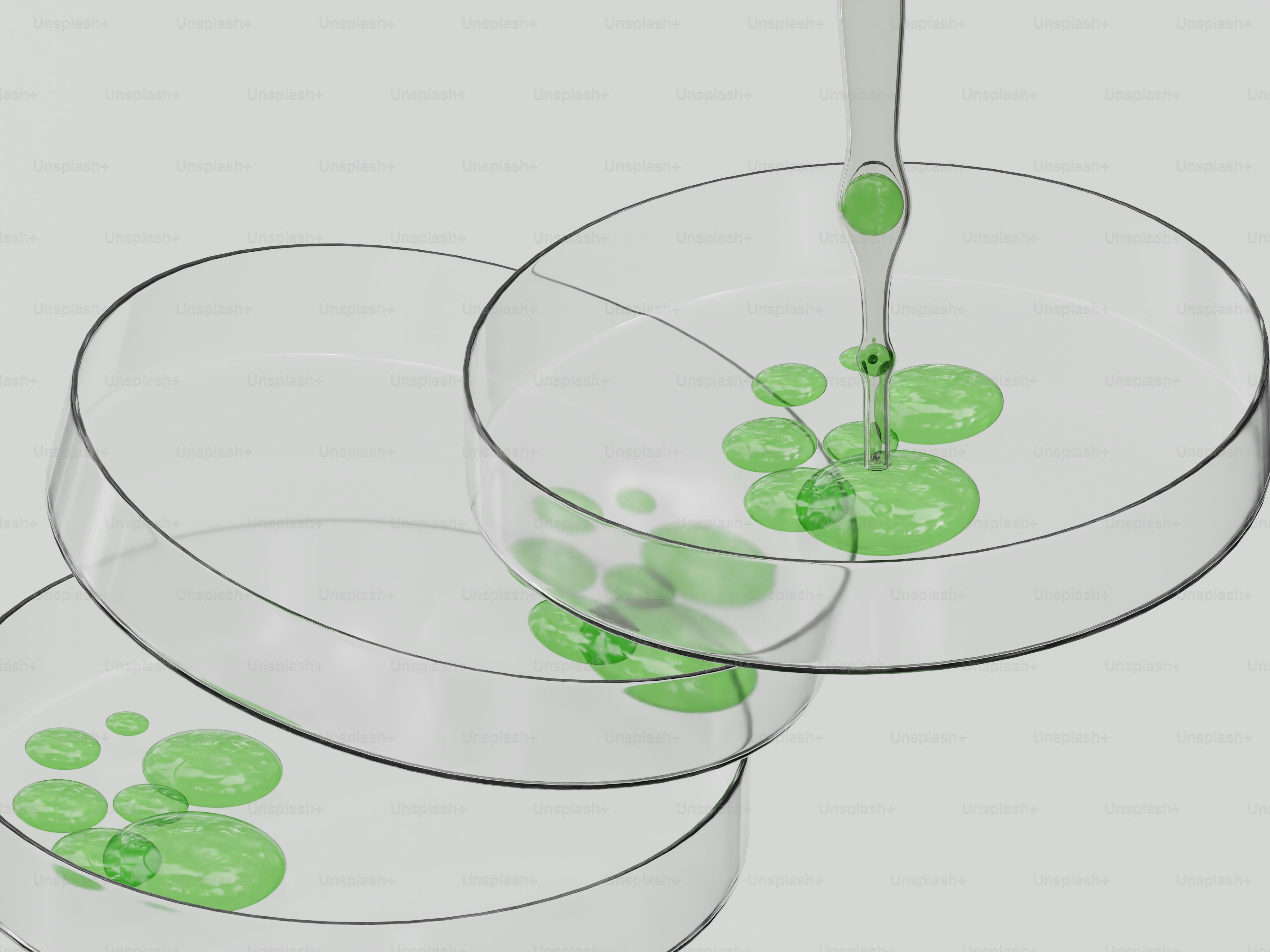 Líquido verde cayendo en placas de Petri