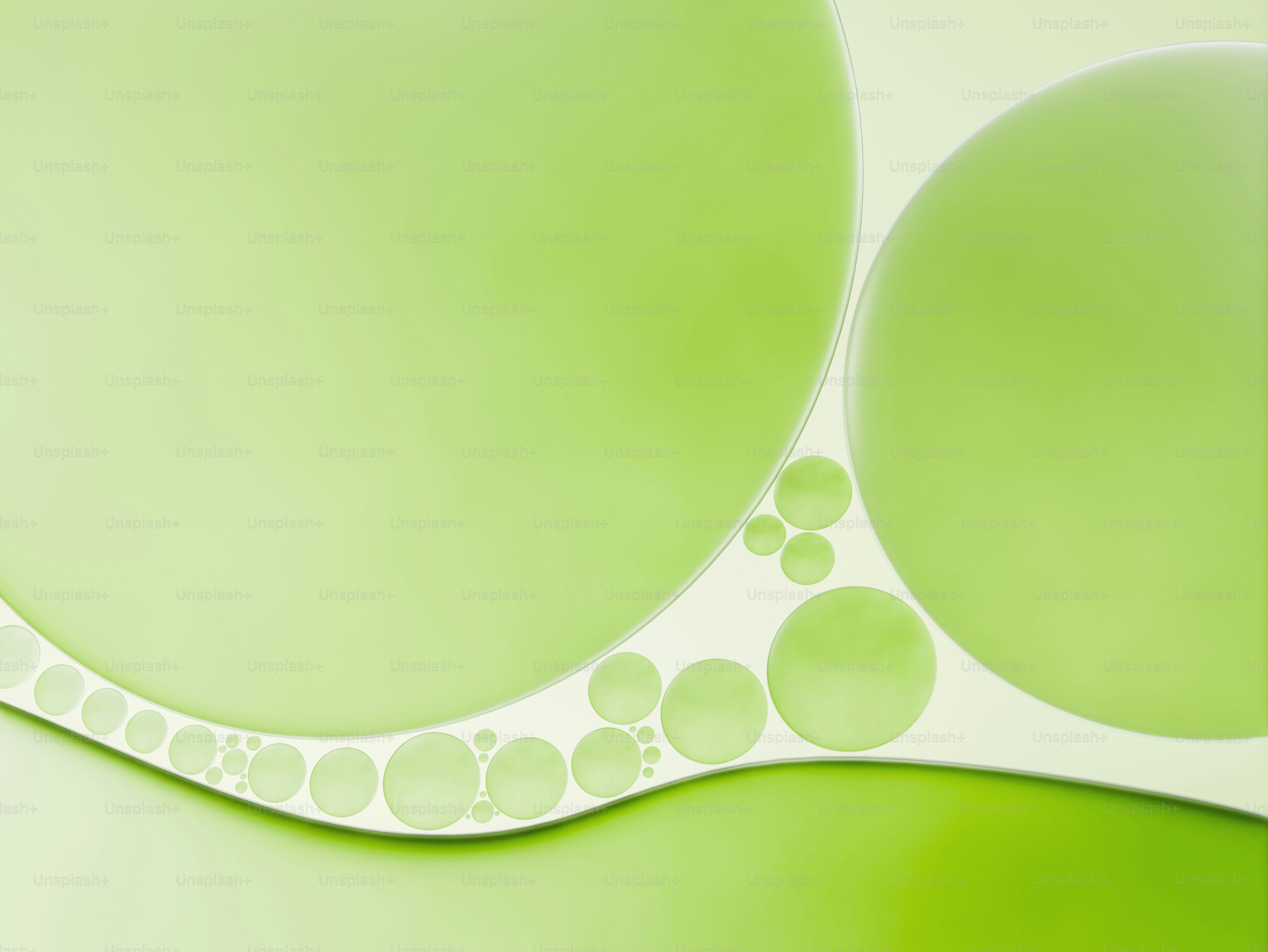 Abstract macro view of green oil bubbles on water