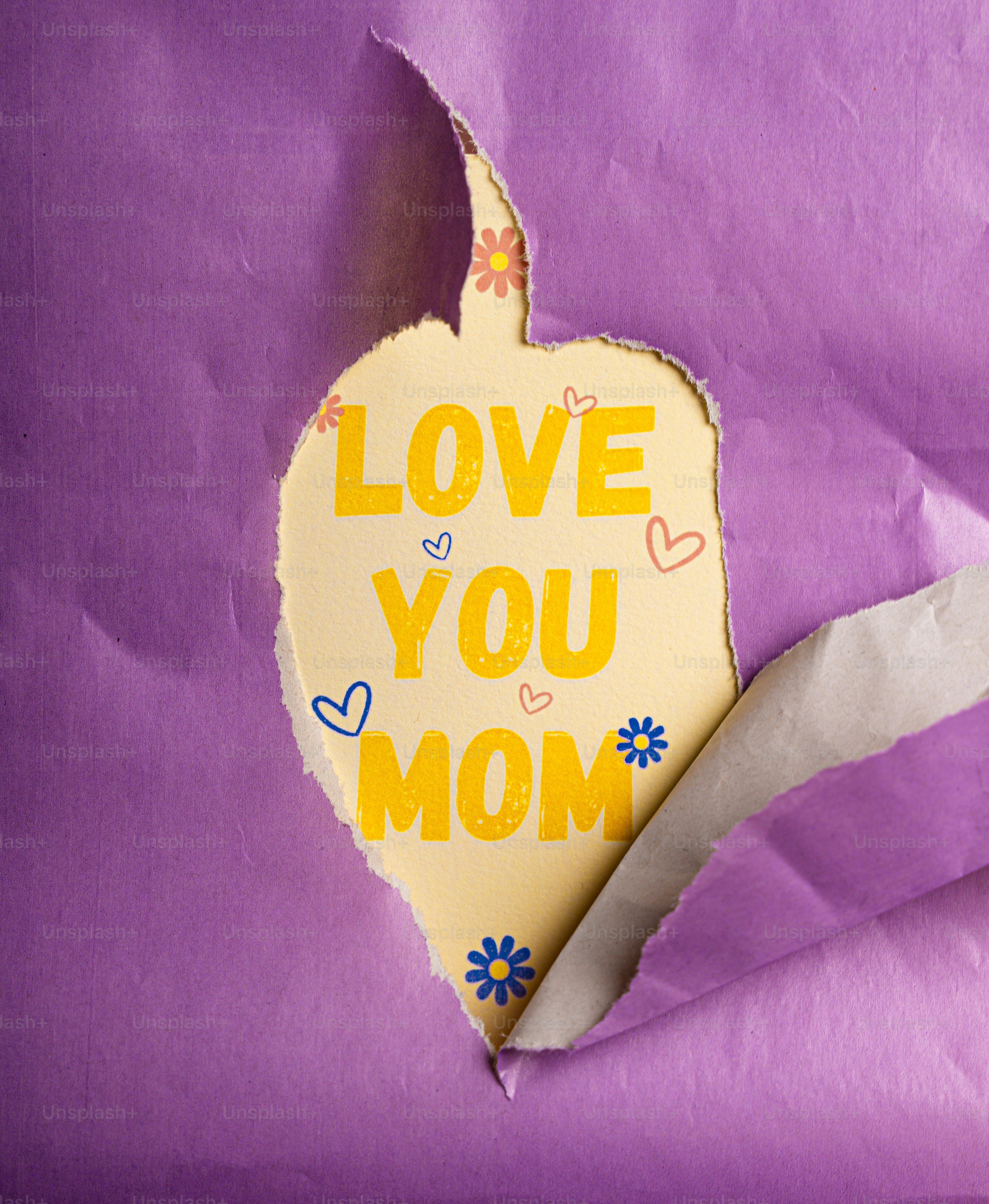Love you mom message on yellow paper with heart.