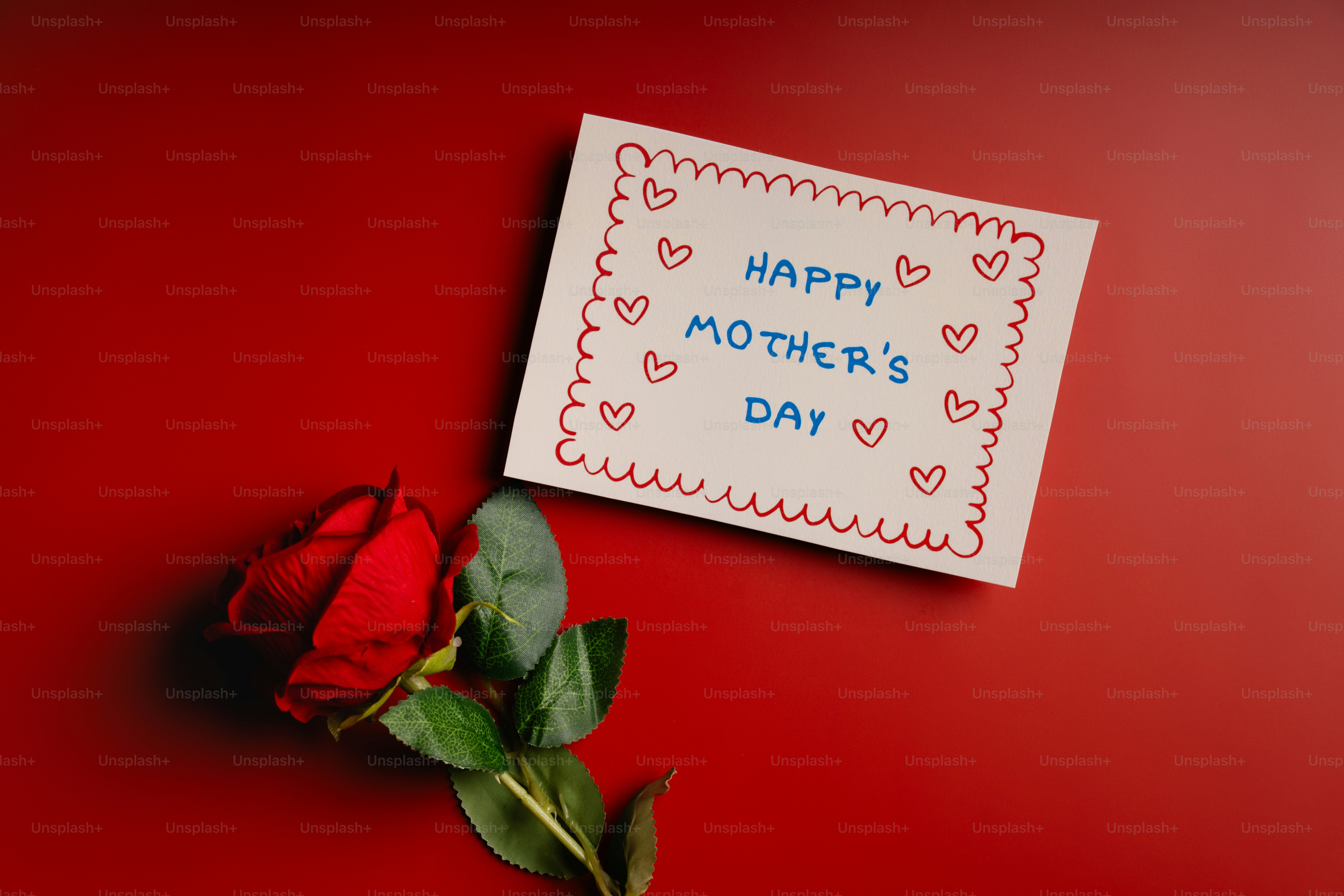 A red rose and a happy mother's day card