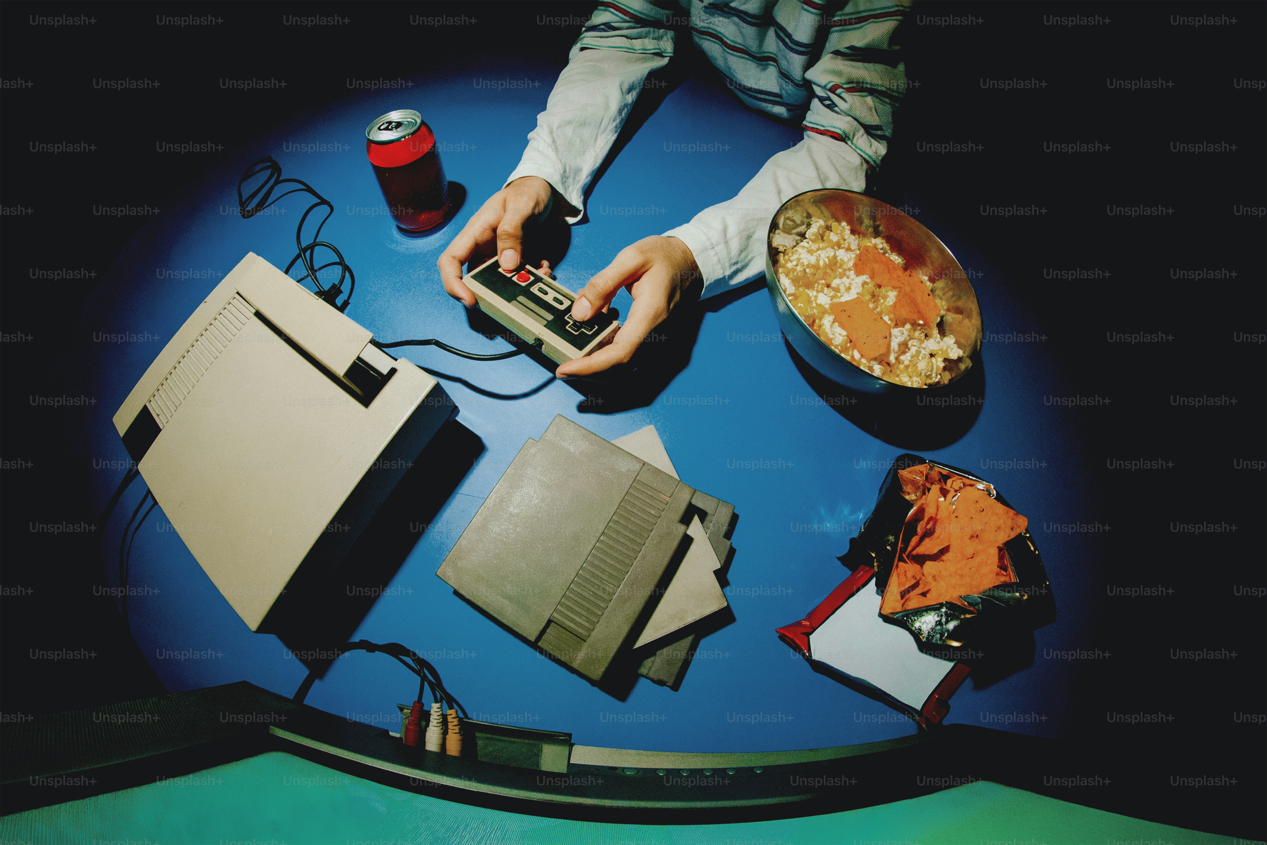 Person playing retro video game with snacks and snacks photo – Fun ...