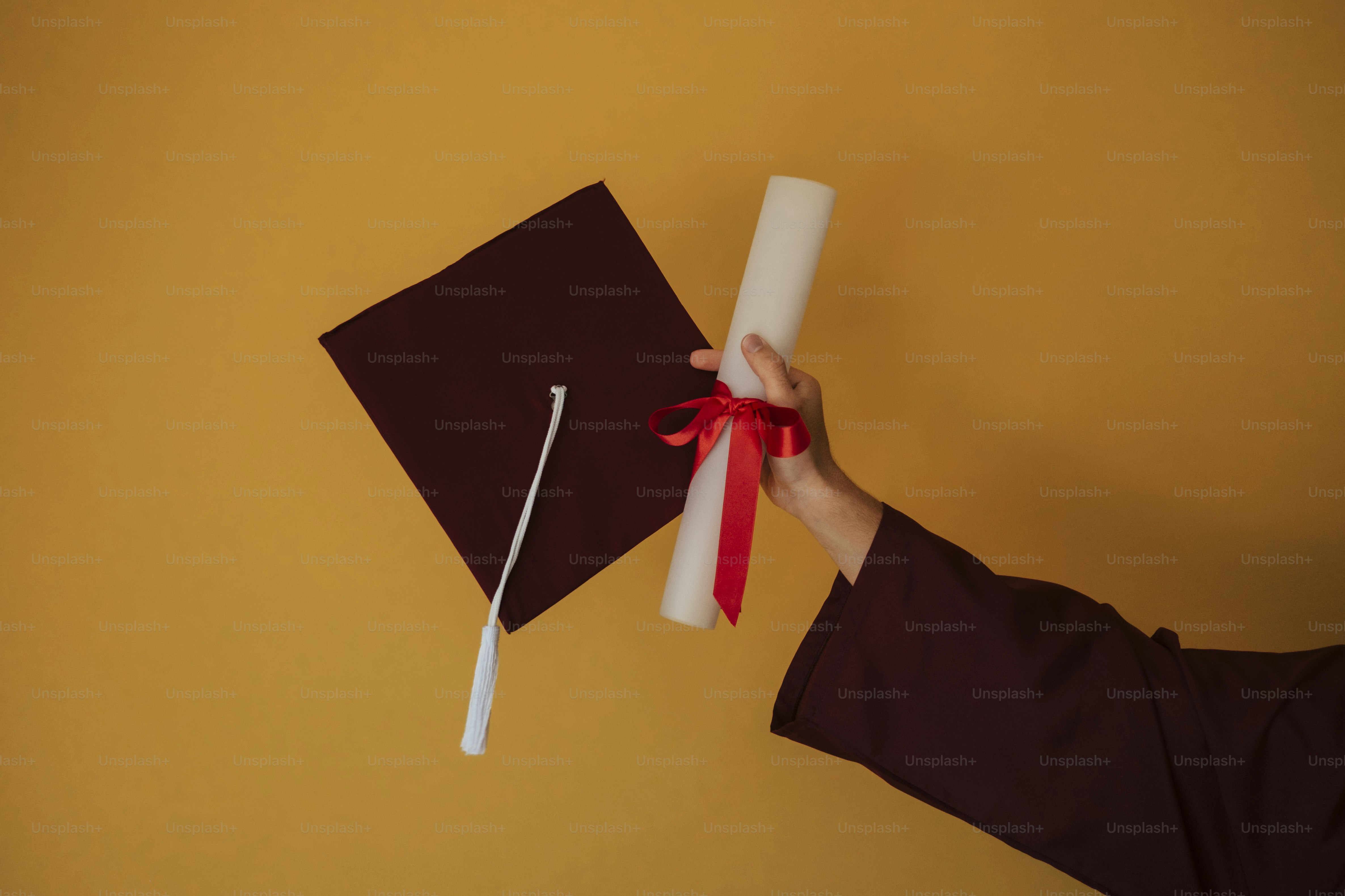 Hand holding a diploma and graduation cap photo – Education Image on ...