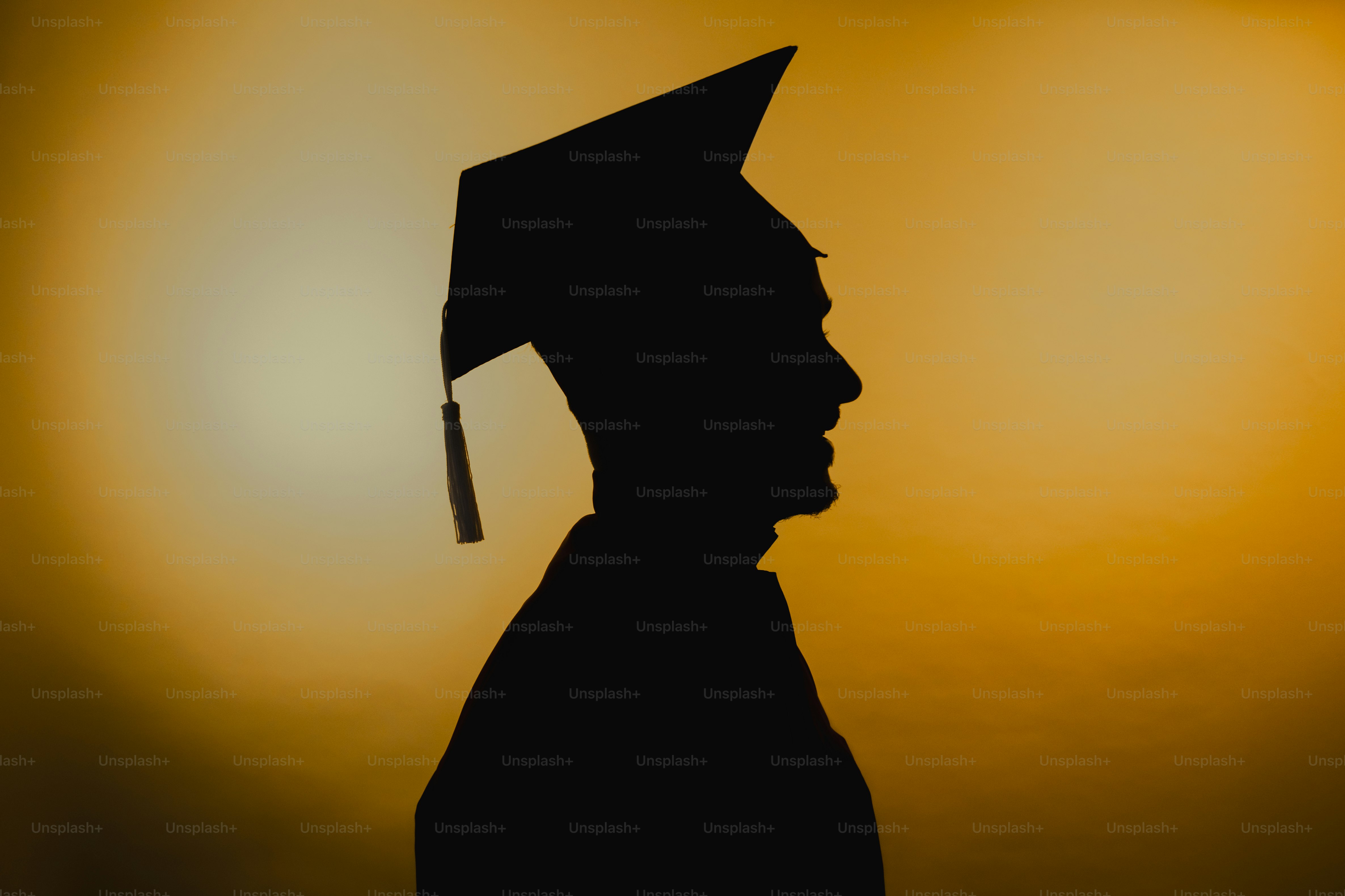 Silhouette of a graduate in a cap and gown.