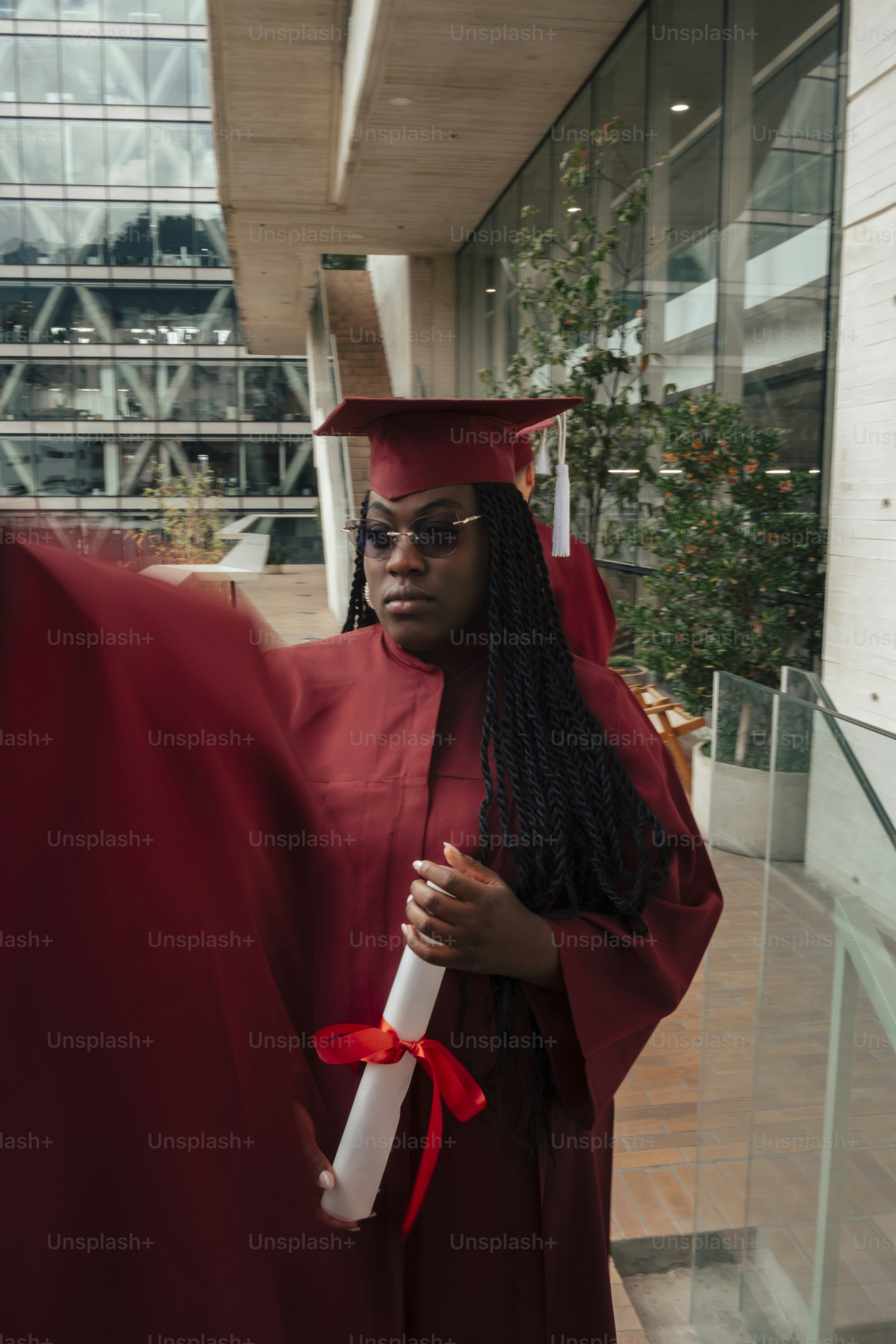 Graduate in cap and gown holds camera taking photo photo – Outdoor ...