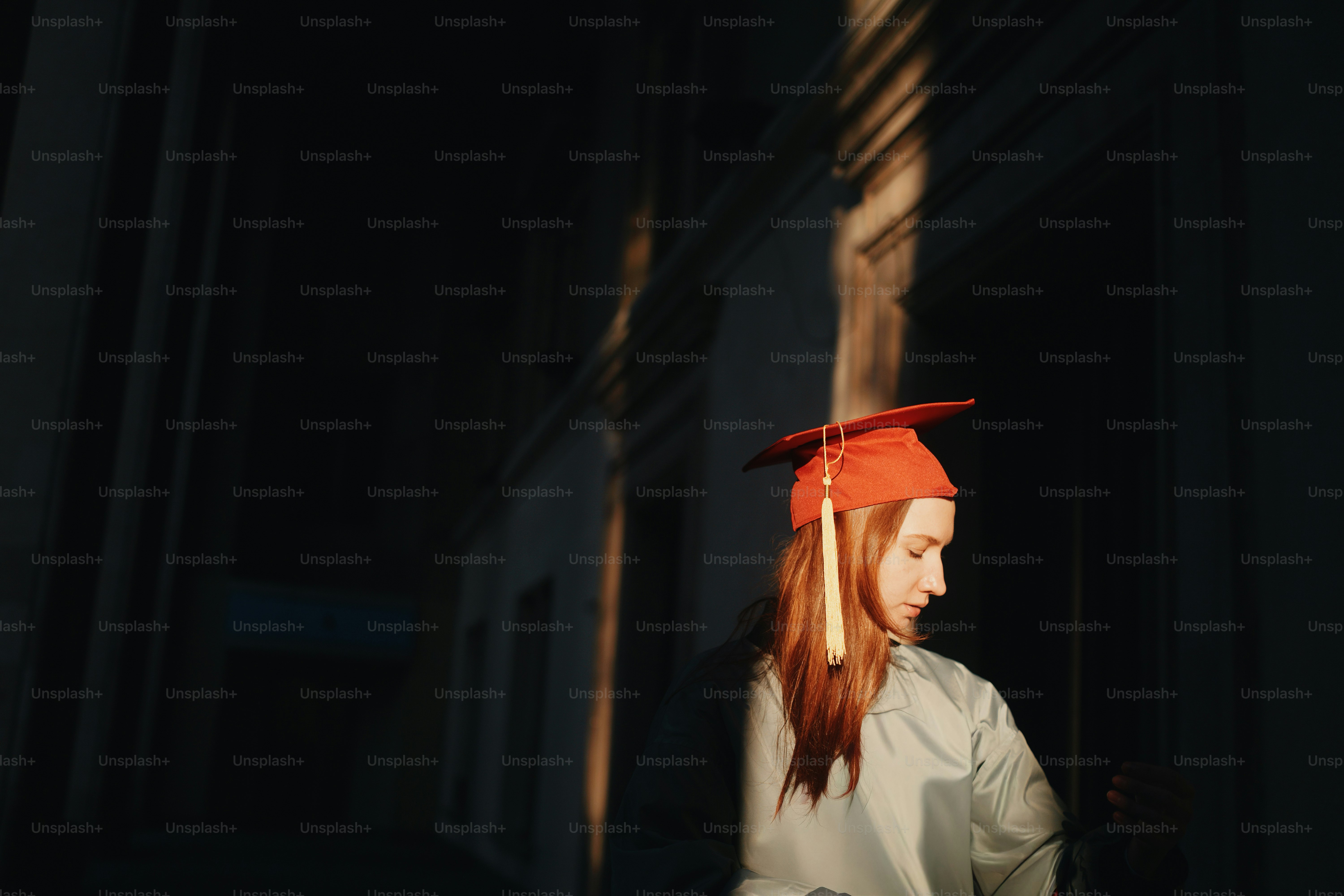 Graduate in cap and gown taking a picture with camera photo – Education ...