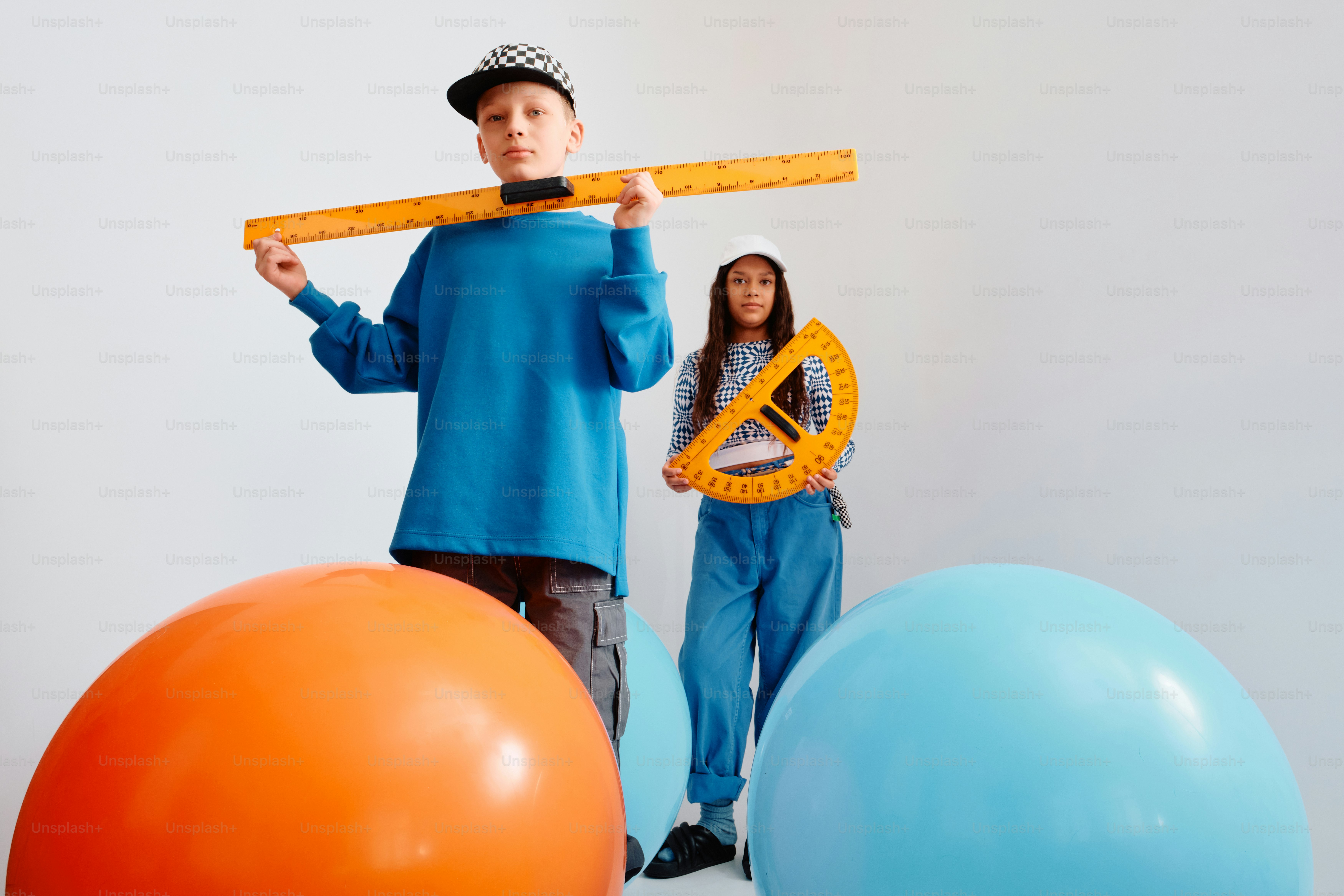 Two children holding large math rulers and protractor photo – Education ...