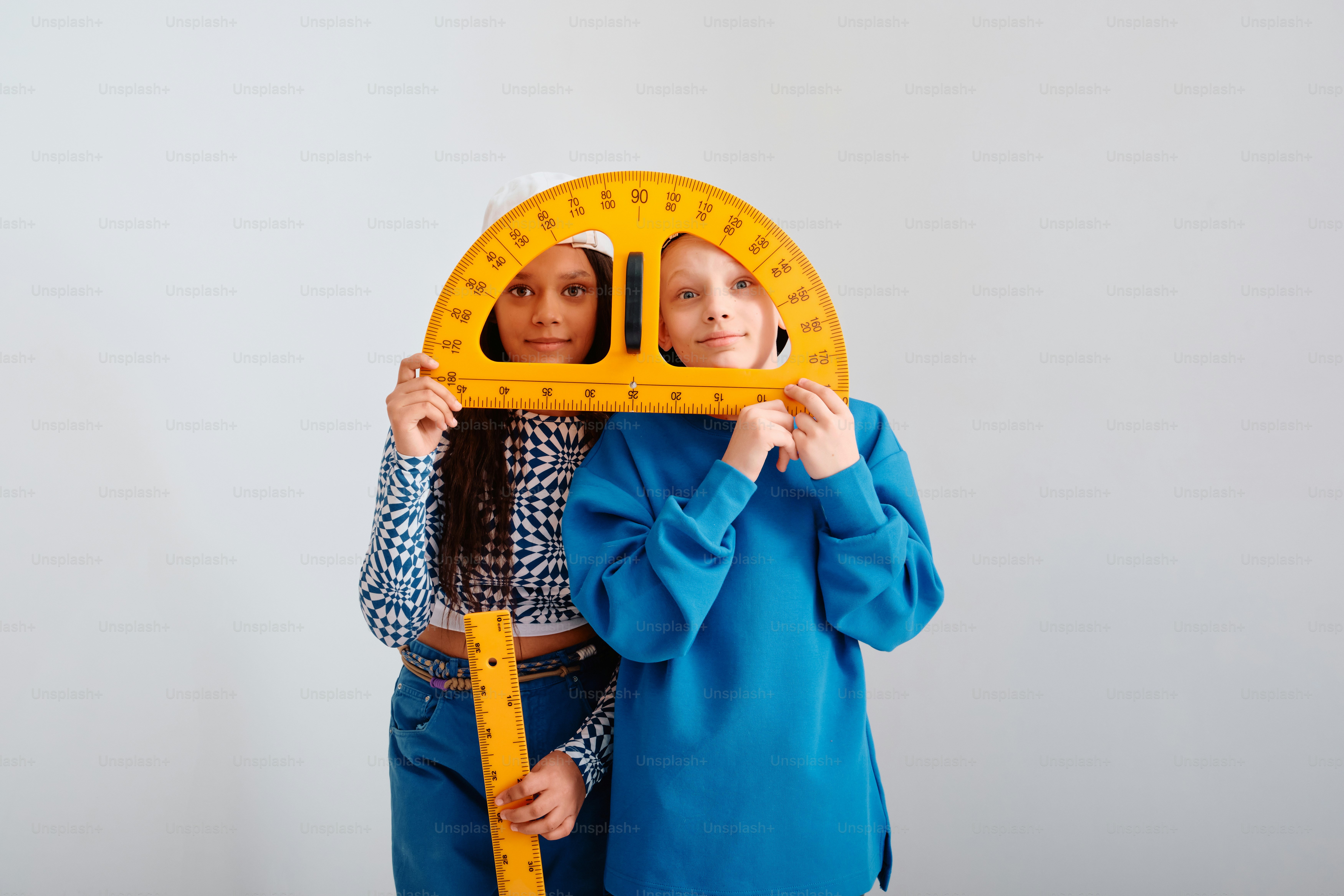Two children holding large math rulers and protractor photo – Education ...